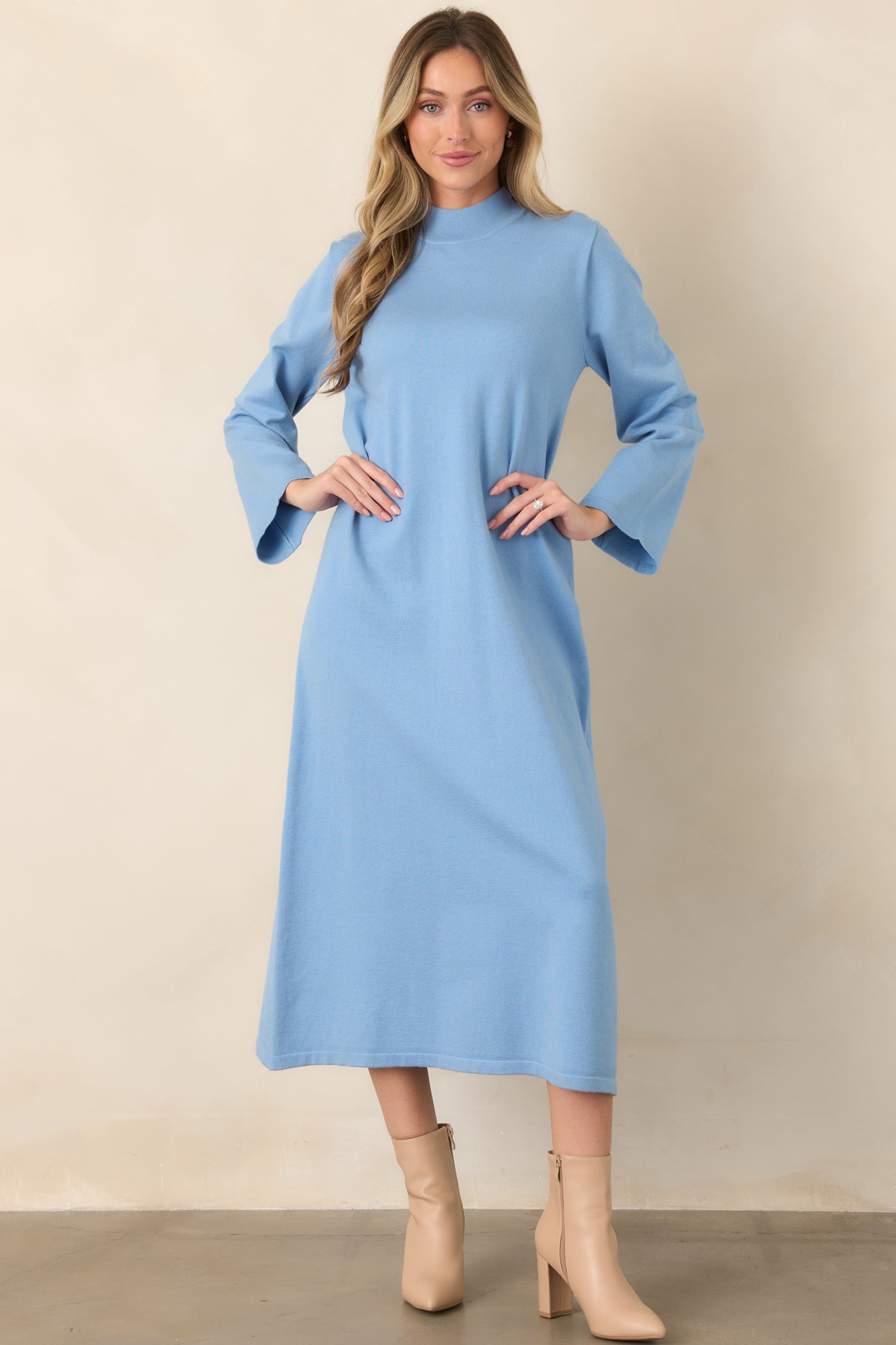 Light blue long-sleeve knit dress featuring a simple straight silhouette, mock neckline, soft stretch construction, and polished finish.