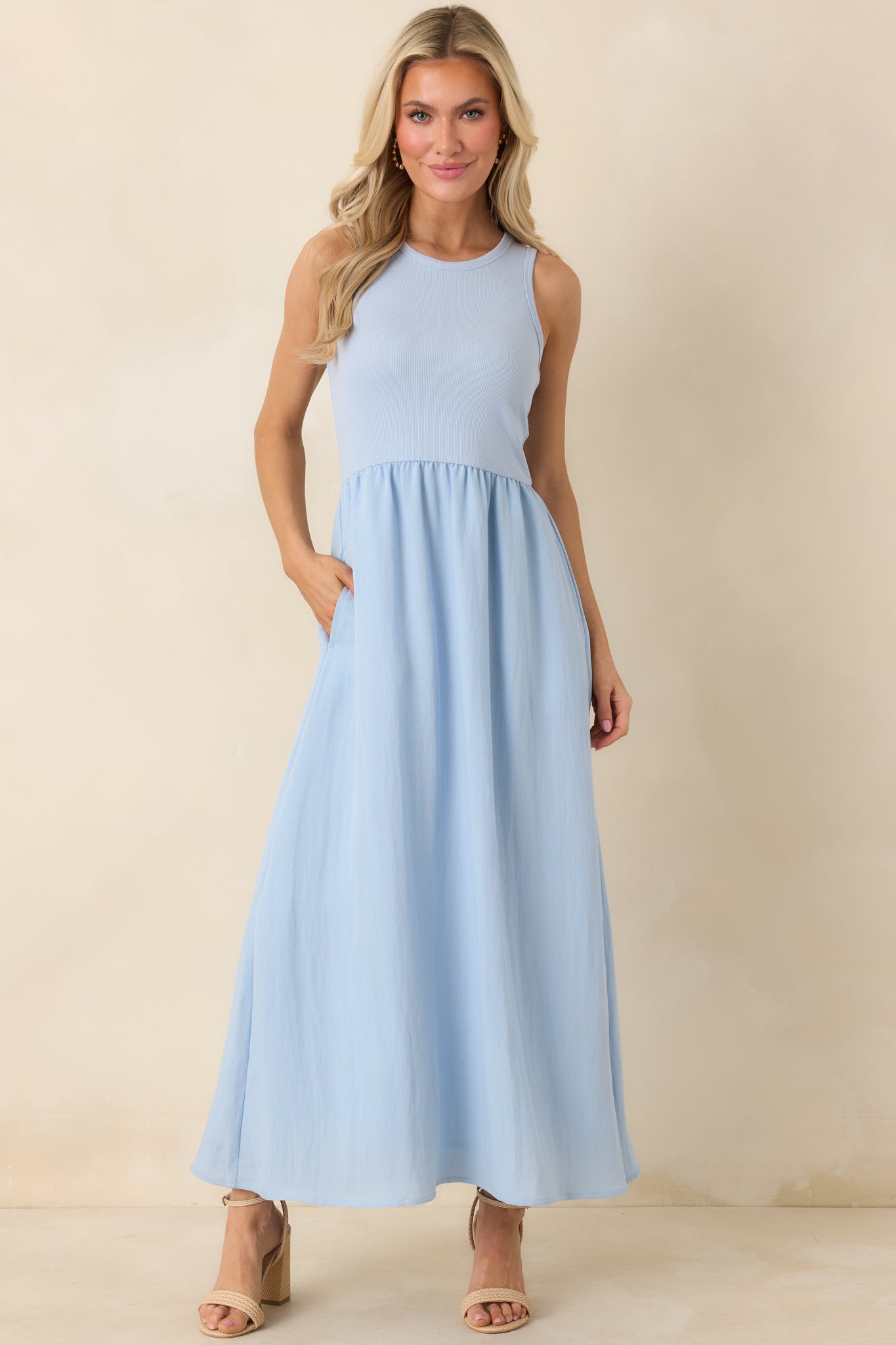 Light blue midi dress featuring a ribbed cotton bodice, round neckline, and textured skirt with functional pockets.