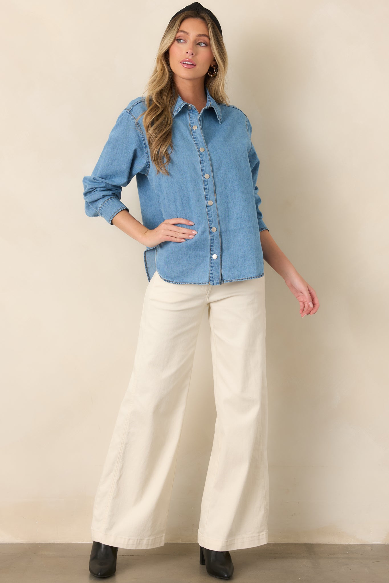Light denim-inspired cotton shirt showcasing a button-down front, adjustable roll-tab sleeves, and a flattering high-low hem.