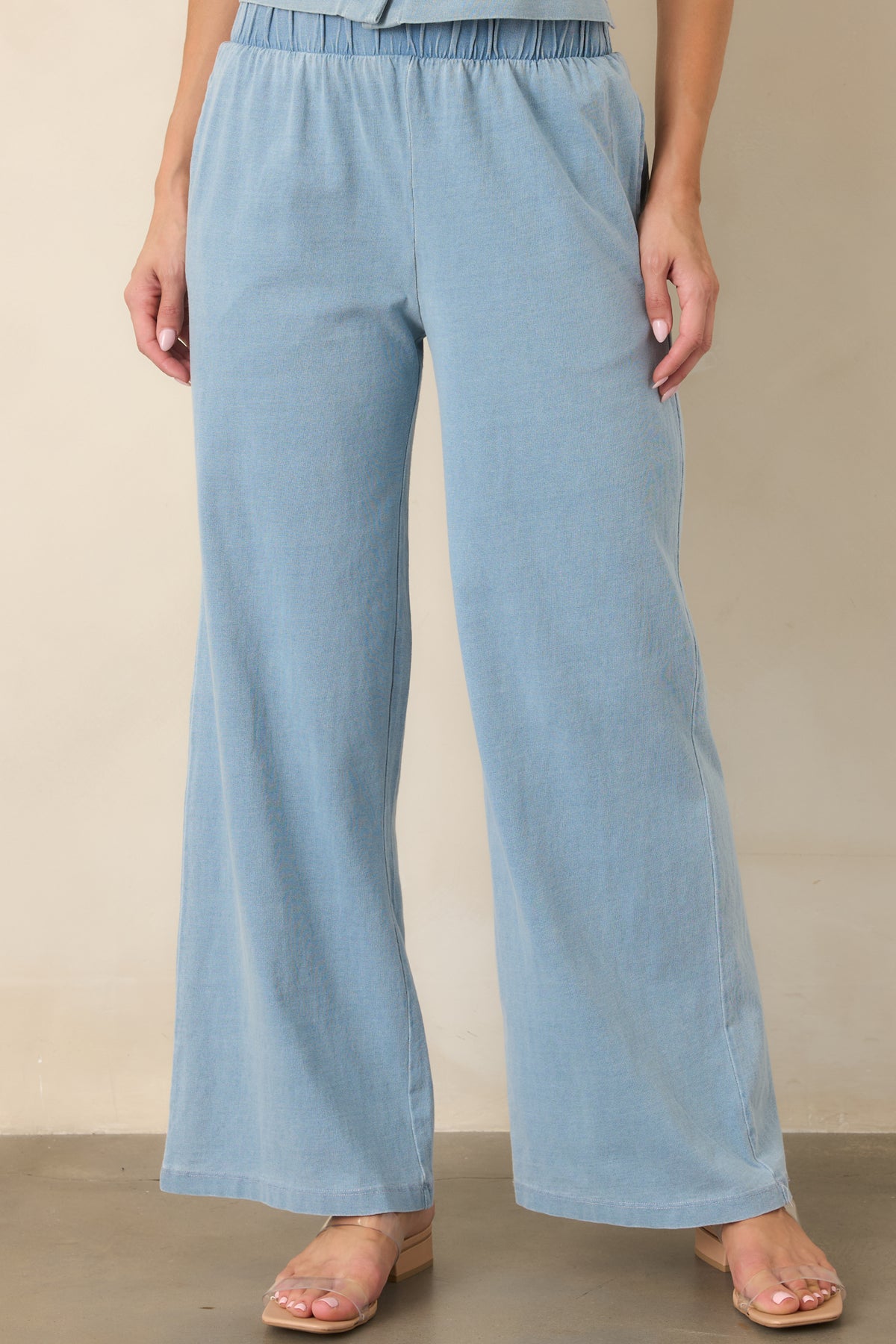 Light denim blue lounge pants showcasing the breathable cotton texture and smooth, relaxed fit through the wide legs.