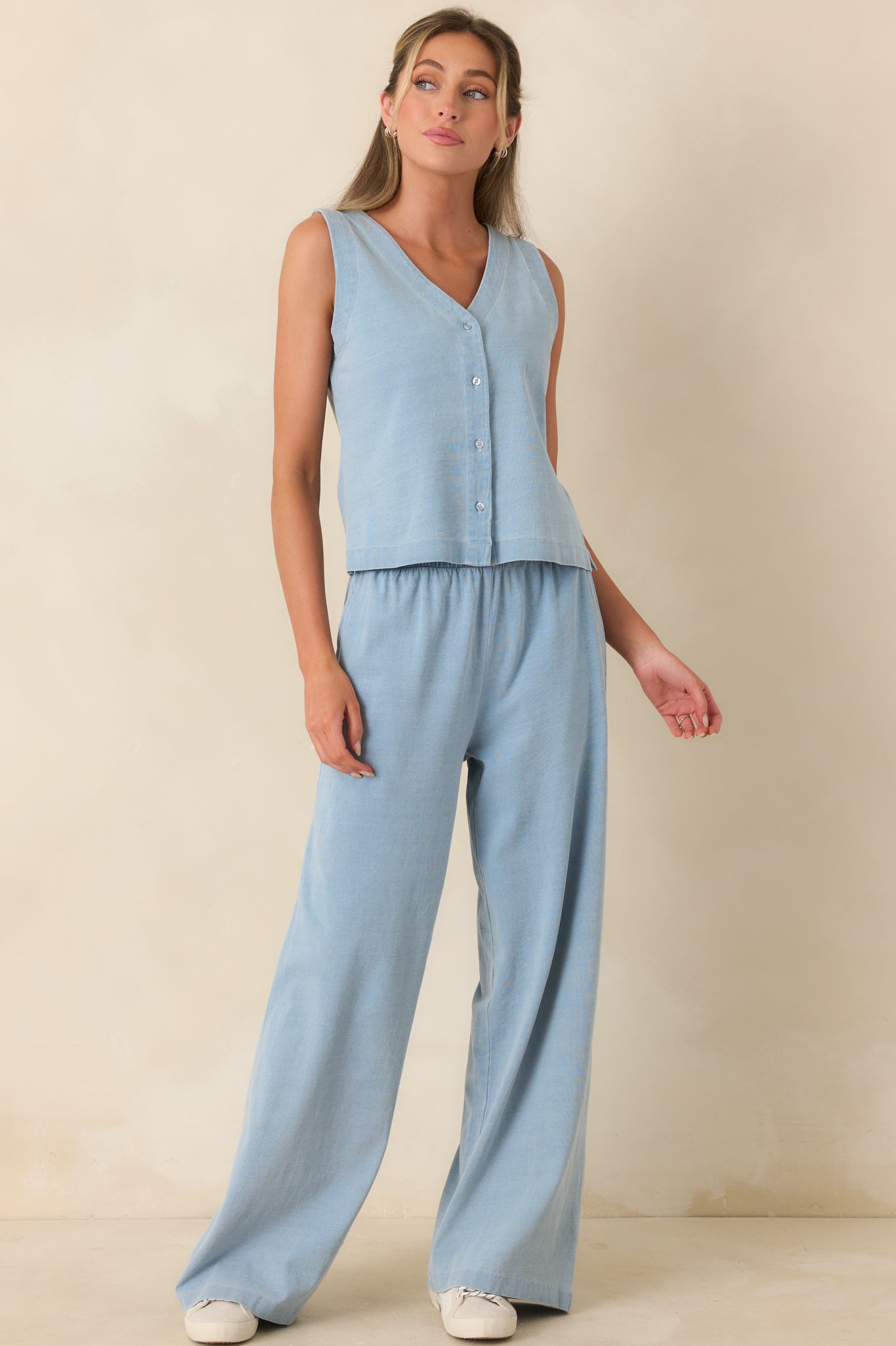 Light denim blue lounge pants featuring a high-rise elastic waistband, relaxed wide leg silhouette, and lightweight cotton fabric.