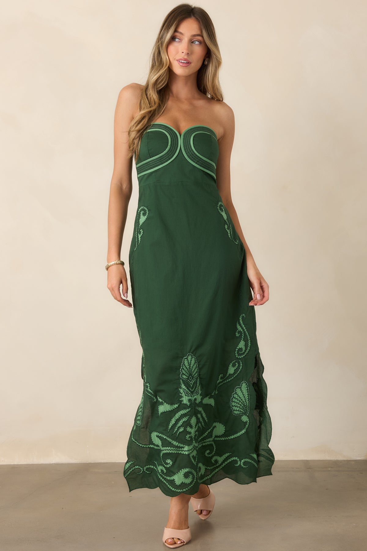 Sleek midi dress showcasing light green scrollwork motifs and a gently scalloped hem.