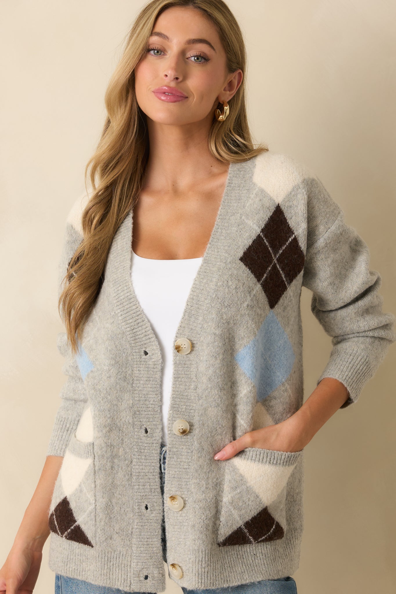 A cropped angled view highlighting the front patch pockets and knit texture in detail.