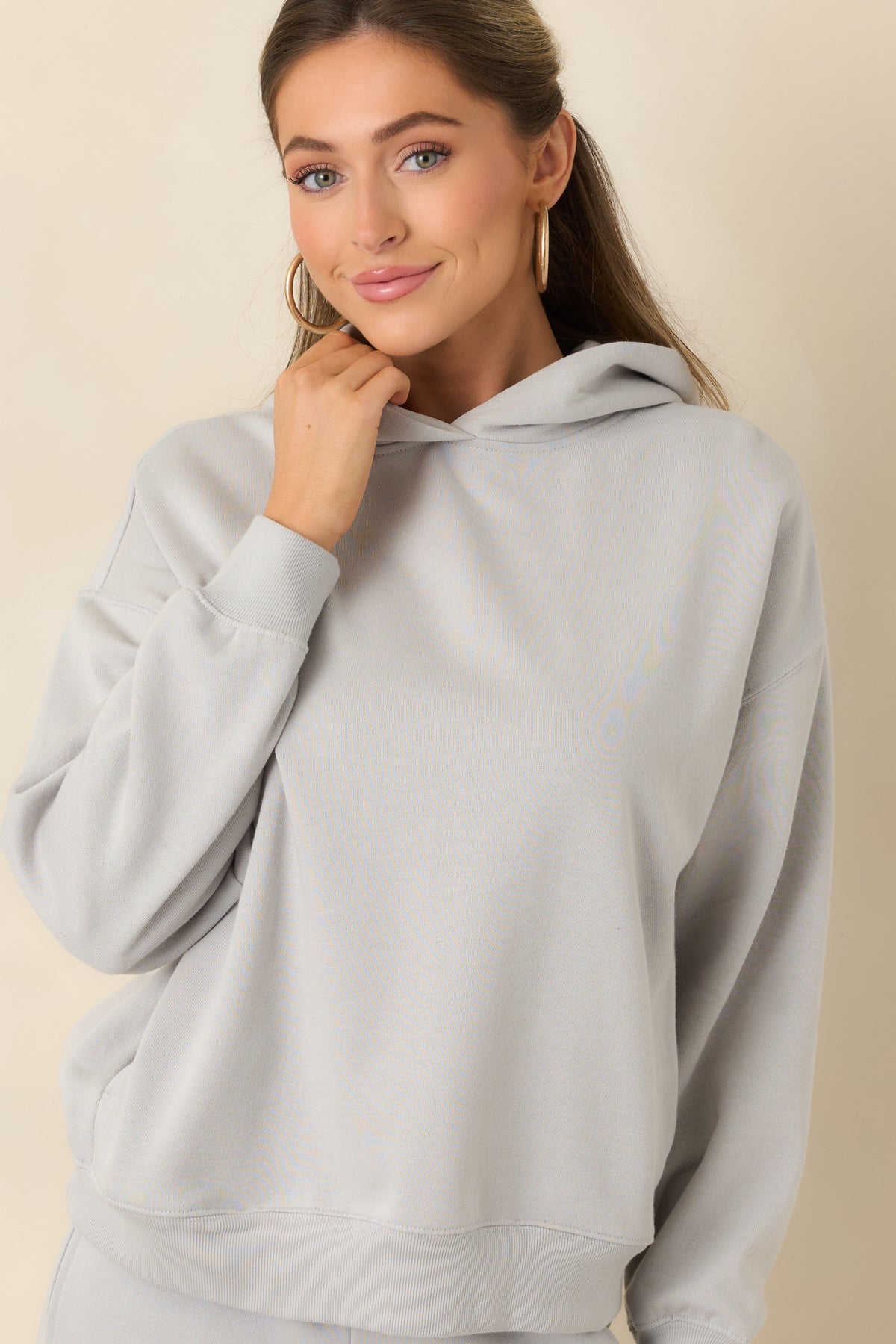 Light grey hoodie highlighting its roomy hood and soft cotton-blend fleece fabric.