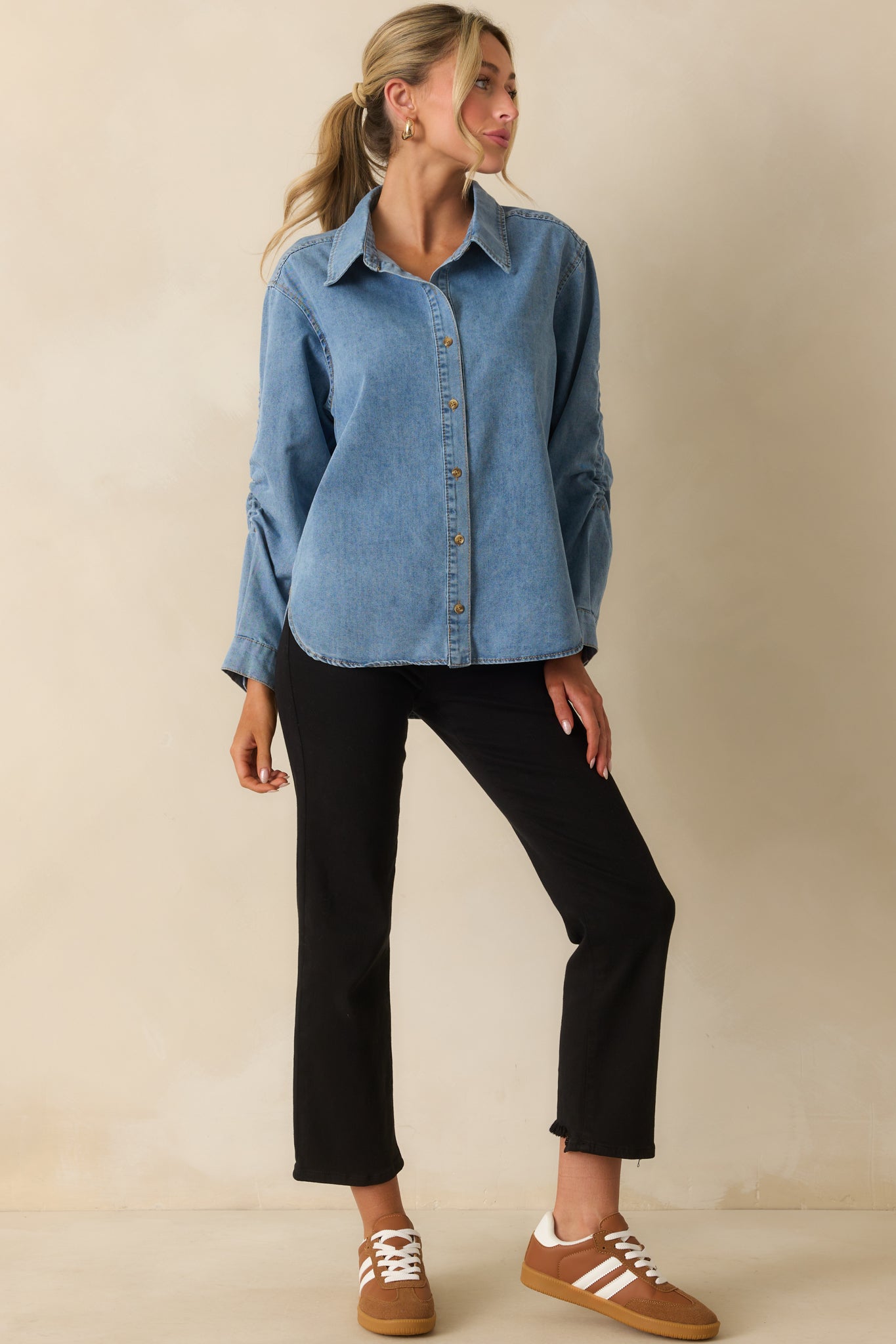Light wash denim shirt with classic collar and relaxed silhouette.
