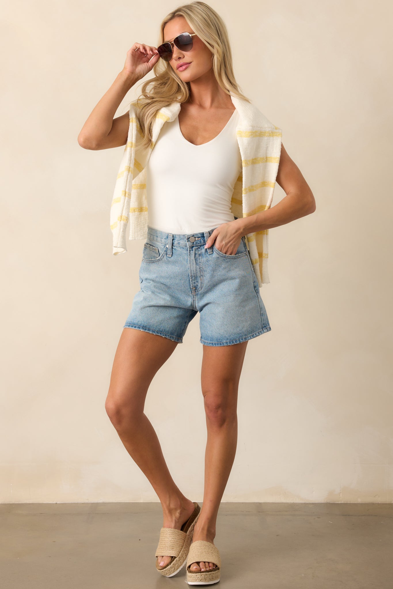 Light wash denim shorts with a classic five-pocket design, highlighting their flattering high-rise waist and timeless denim style.