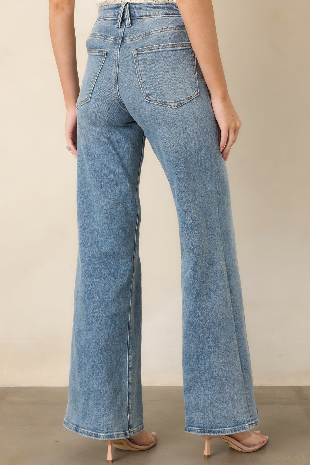 Rear of light wash pants showcasing the wide-leg silhouette and relaxed fit.