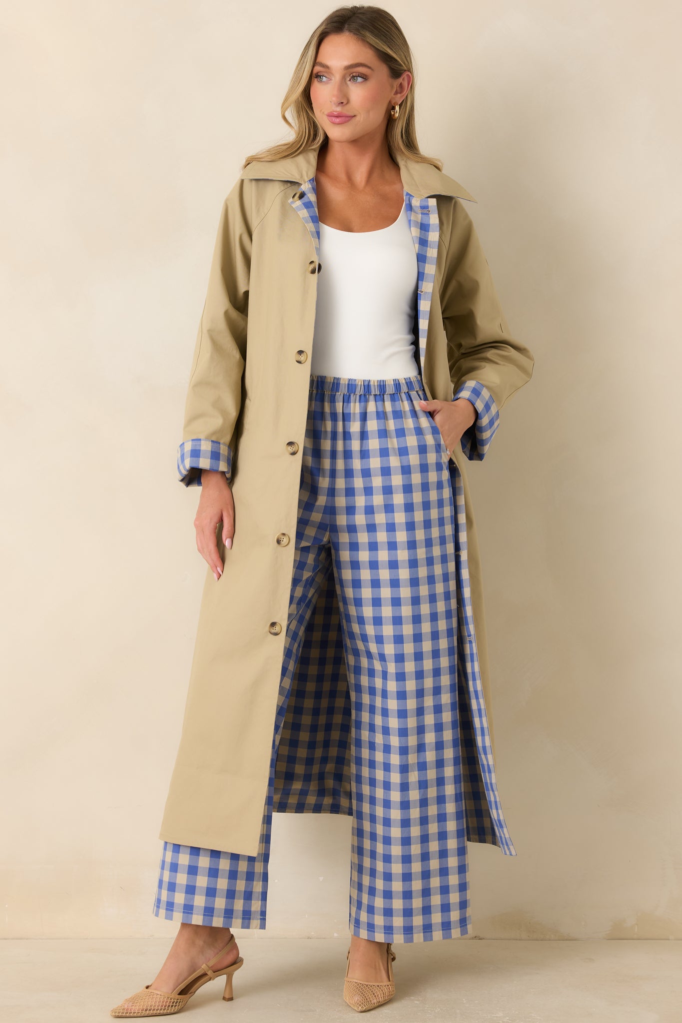 Lightweight beige cotton coat with a reversible design, full-length button front, removable tie belt, and relaxed silhouette.