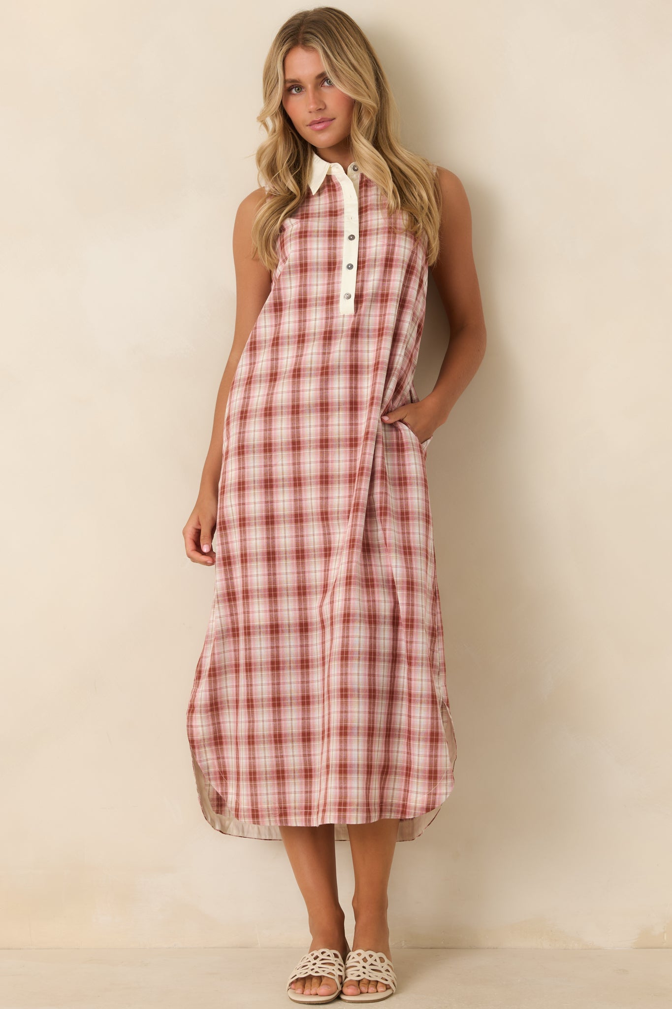 Lightweight cotton dress featuring a button-front neckline, relaxed drape, side pockets, and clean tailored details.