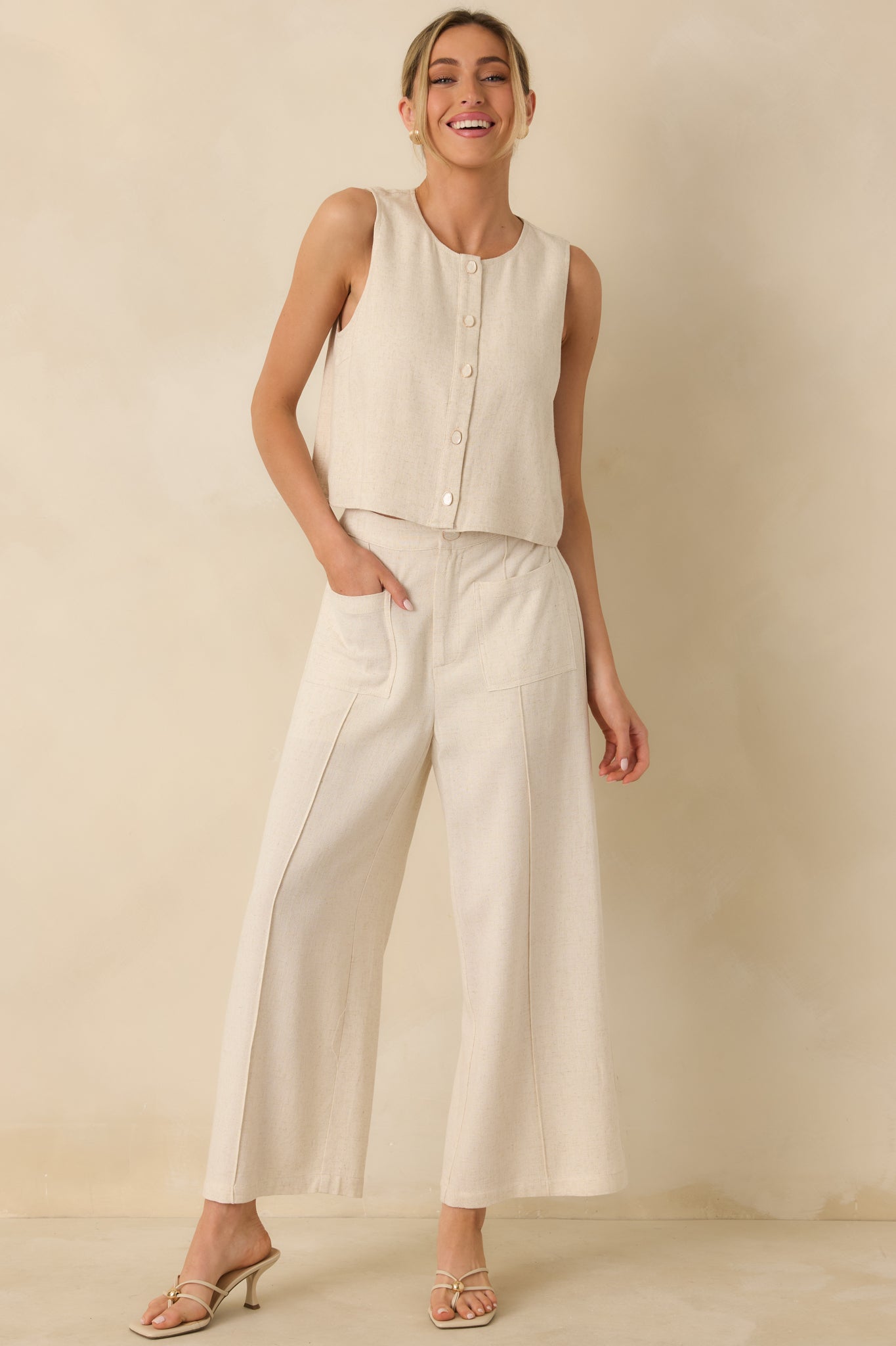 Lightweight linen-blend button-up top with easy drape, sleeveless cut, and refined casual silhouette.
