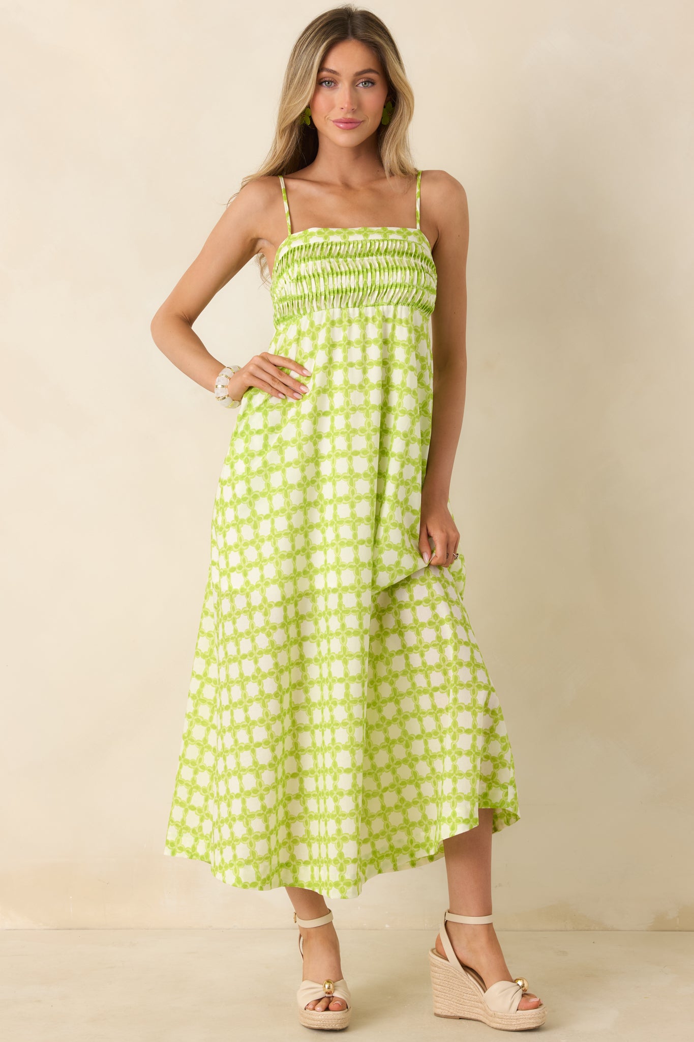 Lightweight cotton dress with stitched pleats, smocked detailing, and an easy, feminine shape.