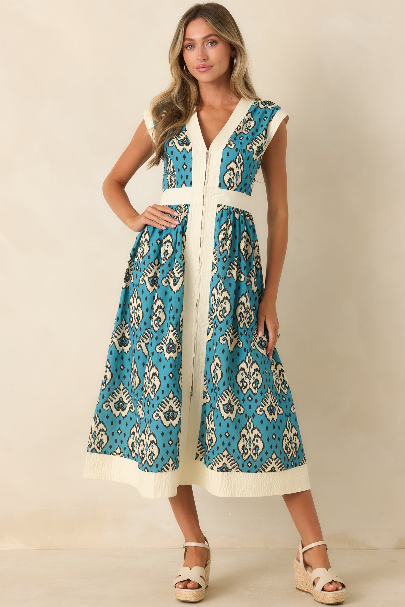 Lightweight cotton midi dress featuring an ikat-inspired print, structured shape, and ivory textured trim details.