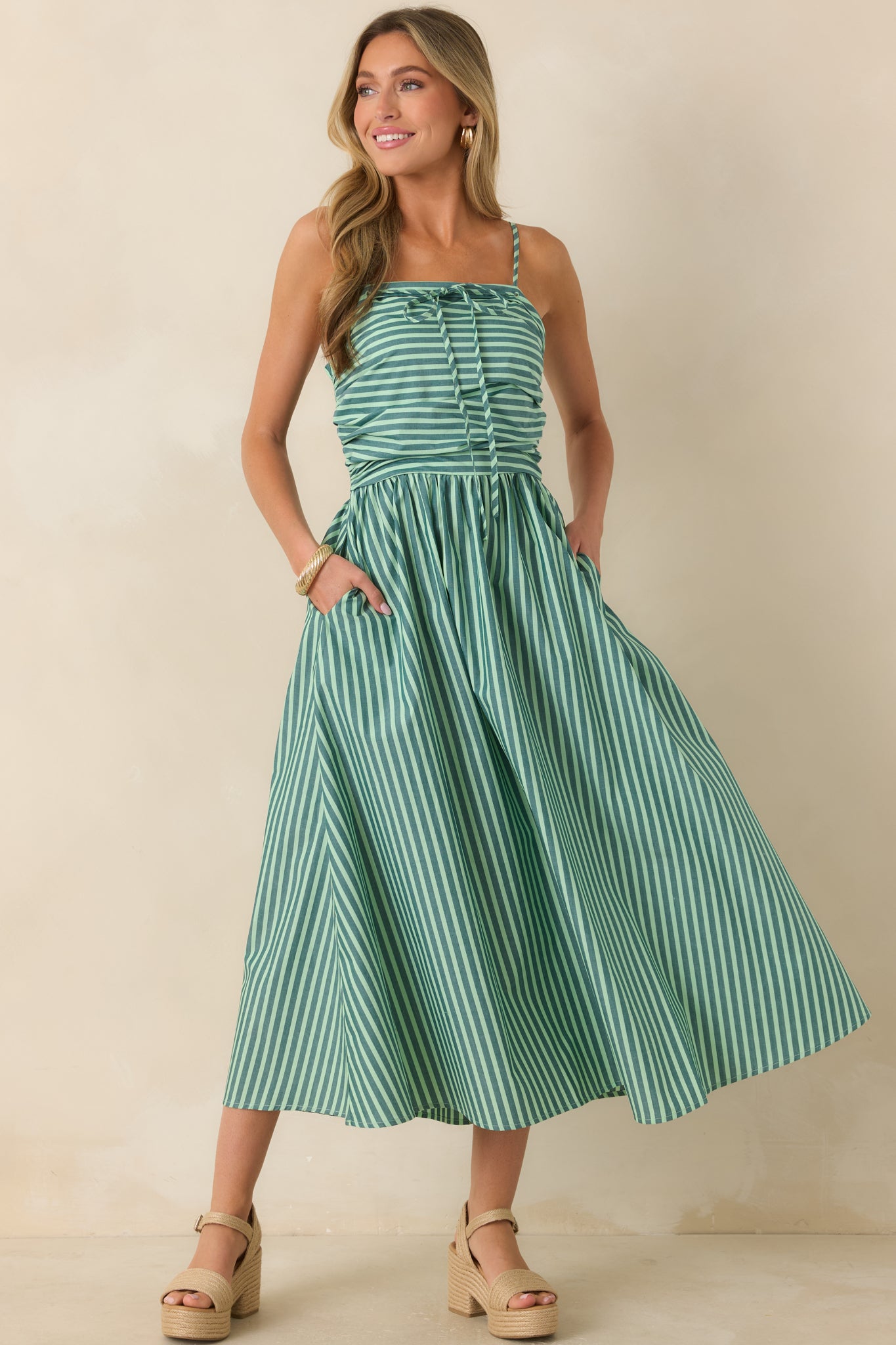 Lightweight cotton maxi dress showcasing soft green and ivory stripes, a gathered waist, straight neckline, and a breezy full skirt.