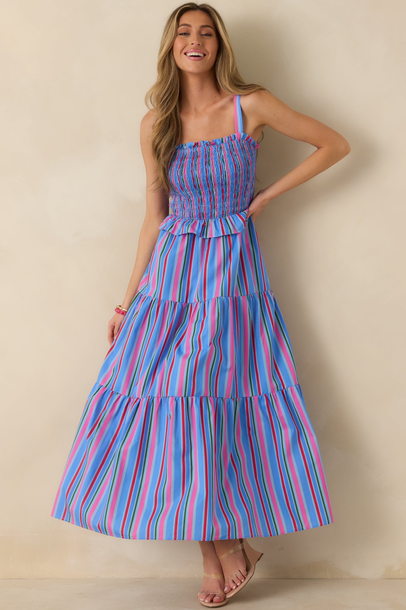 Lightweight cotton maxi dress featuring shades of blue, pink, and green with a flowing tiered skirt.