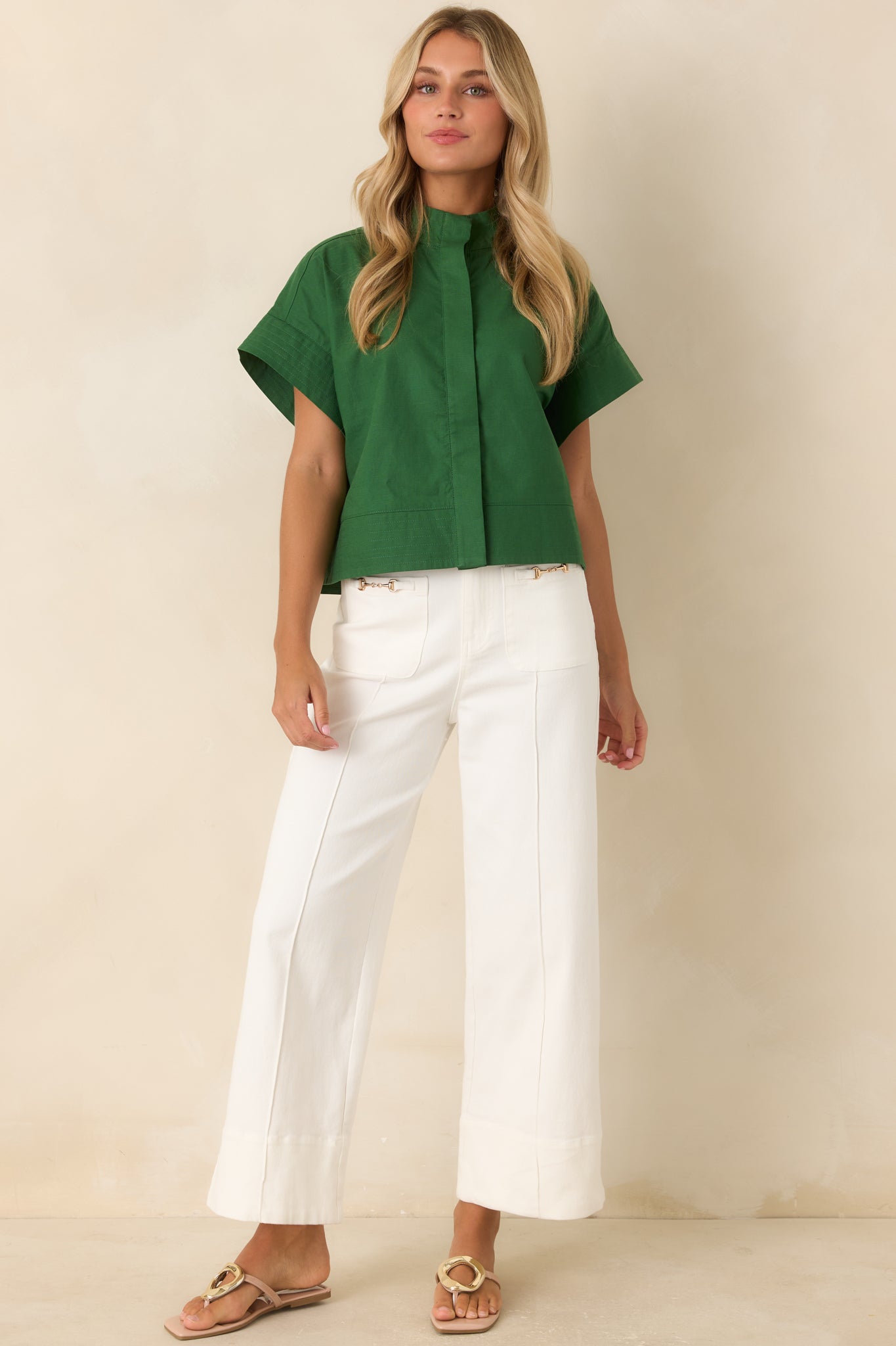 Lightweight cropped top designed with a relaxed fit, drop shoulders, cuffed sleeves, subtle hem stitching, and a polished finish.