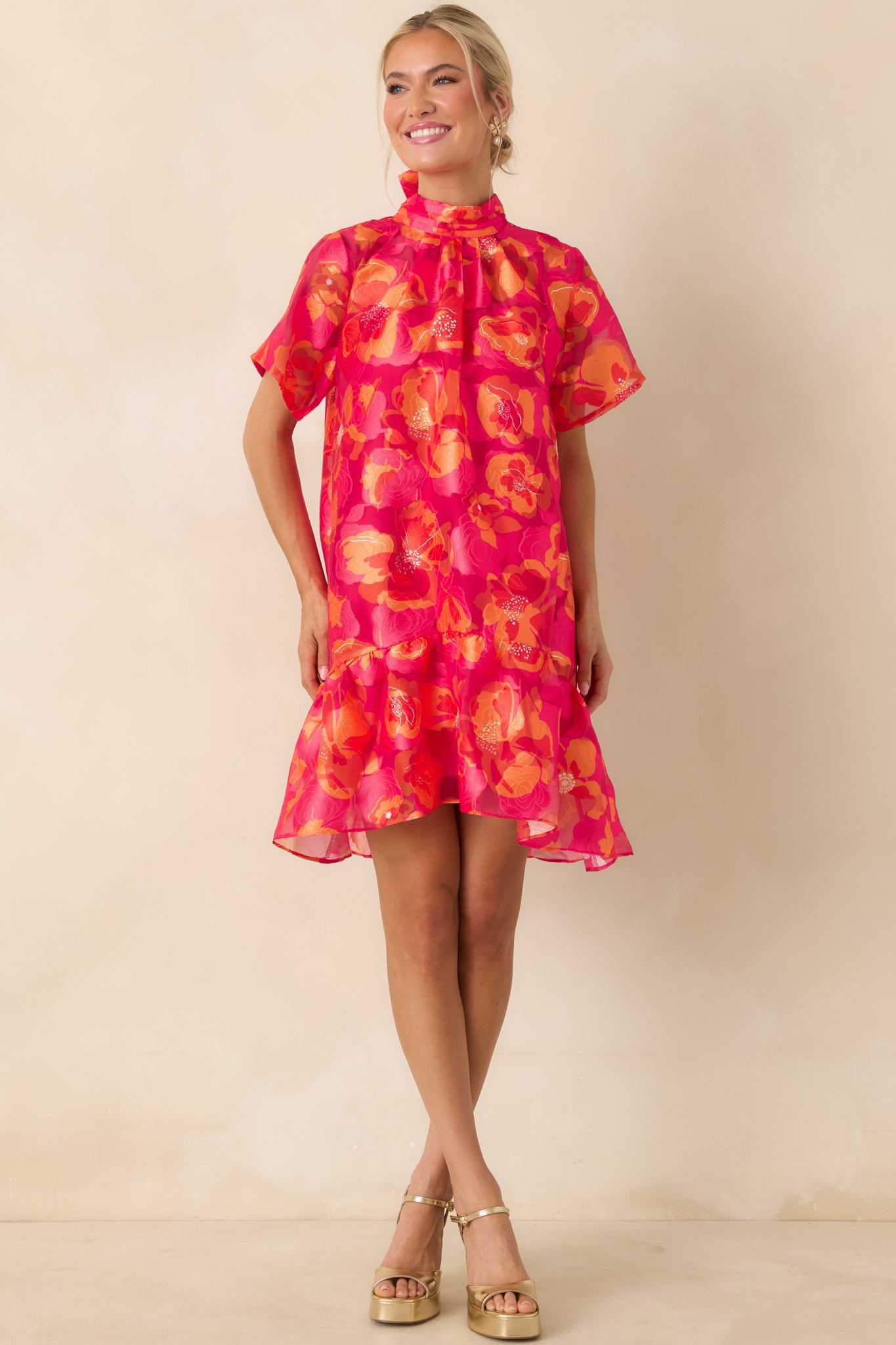 Lightweight dress featuring short sleeves, soft drape, and playful tiered ruffles at the hem.