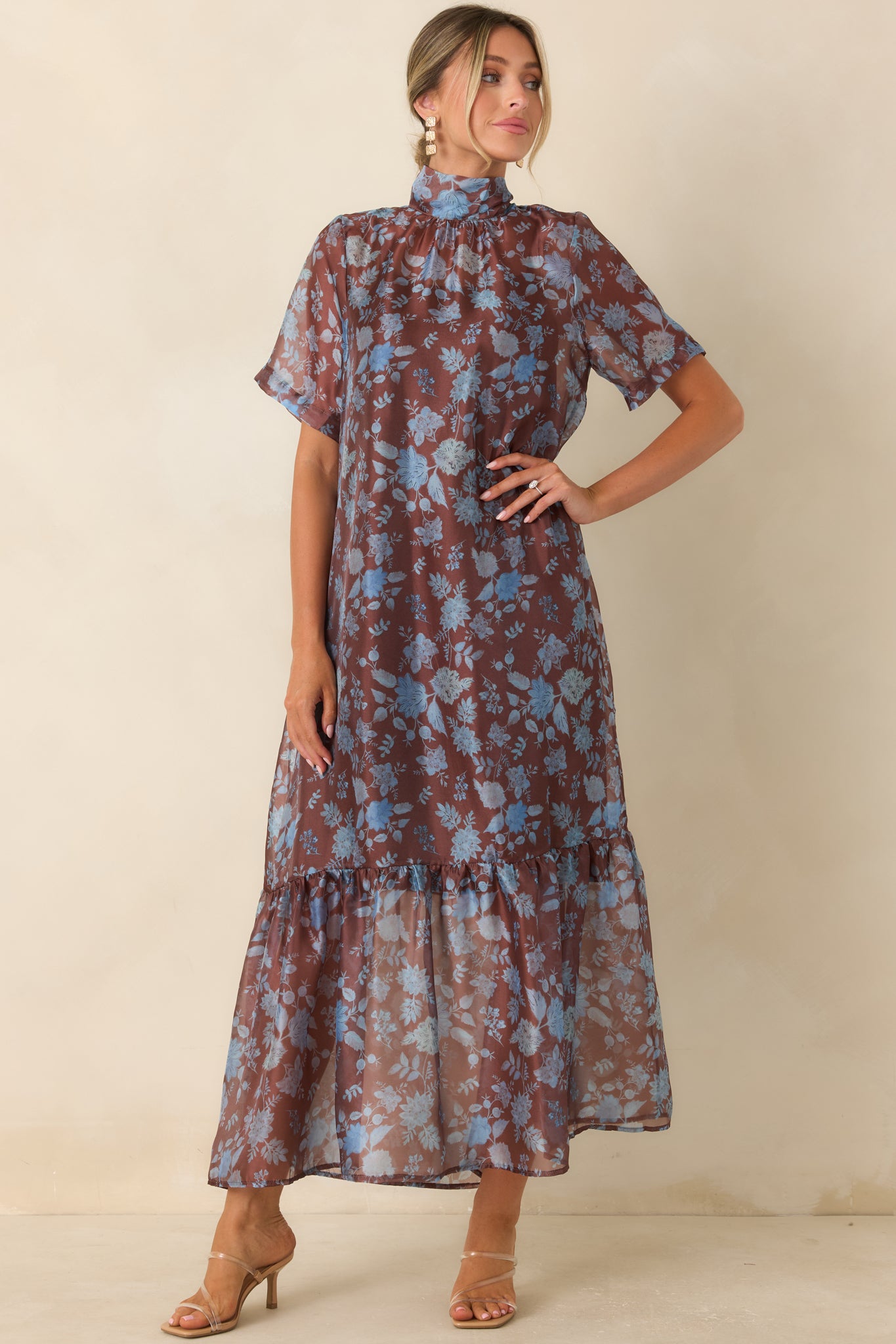 Lightweight floral dress showcasing a tiered hem, airy overlay, and elegant maxi length with graceful movement.