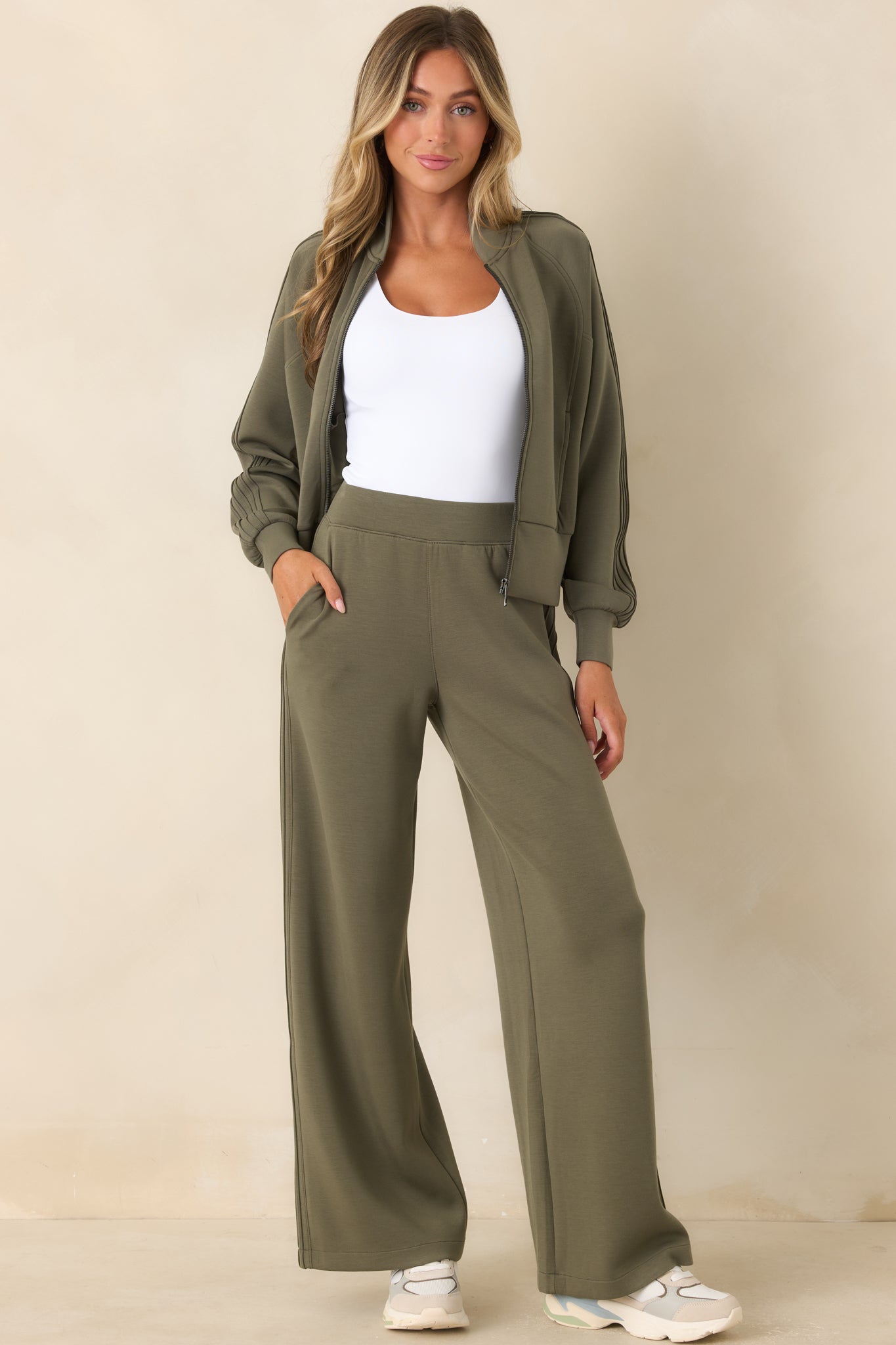 Lightweight herb green pants showcasing a smooth pull-on waistband, relaxed wide-leg silhouette, and streamlined outer seam details.