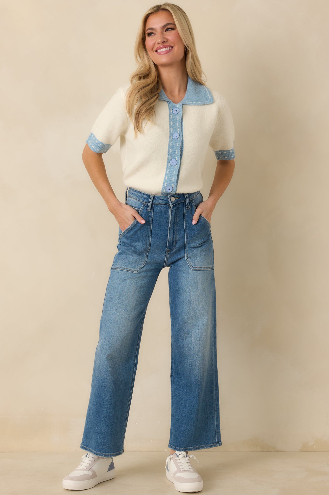 Lightweight ivory button-front cardigan designed with short sleeves and crisp light blue trim outlining each edge.