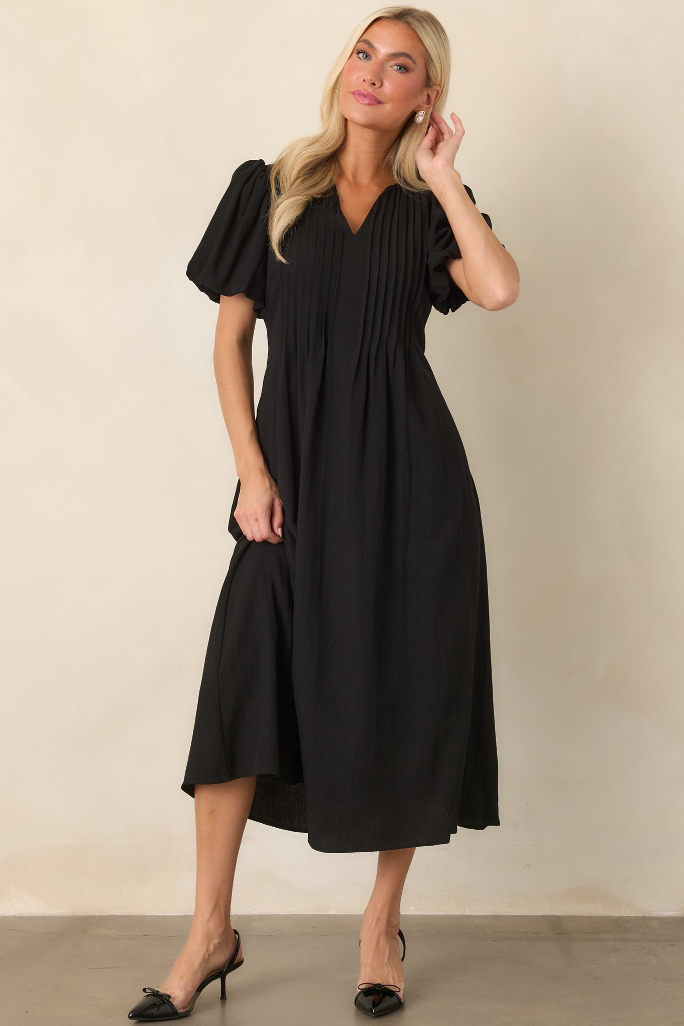 Lightweight midi dress combining a linen-like texture, V-neckline, puff sleeves, and subtle pintuck detailing for added dimension.