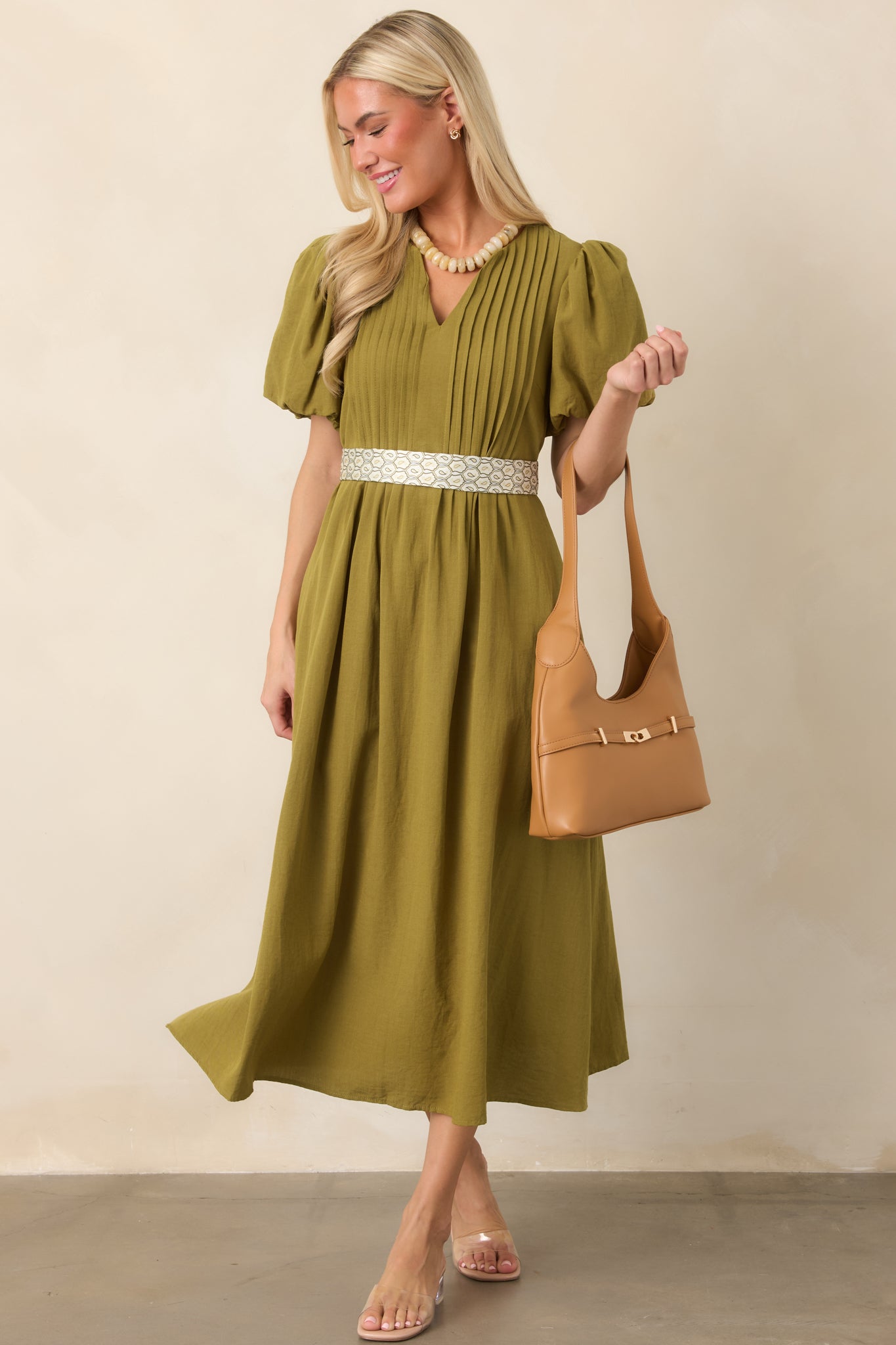 Lightweight midi dress with a linen-like texture, V-neckline, pintuck detailing, softly gathered puff sleeves, and a flowing skirt.