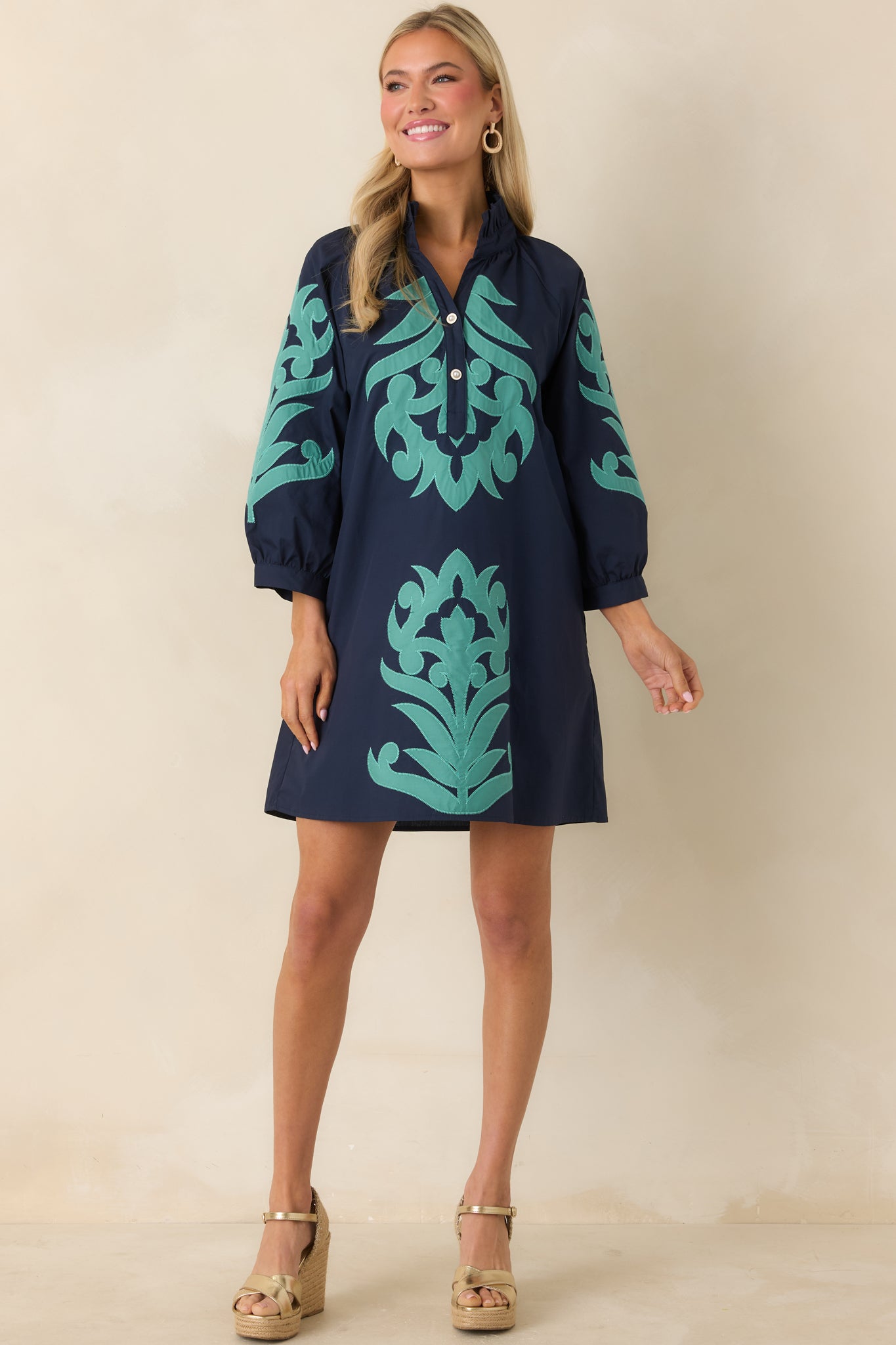 Lightweight navy dress with three-quarter sleeves and eye-catching aqua accents.