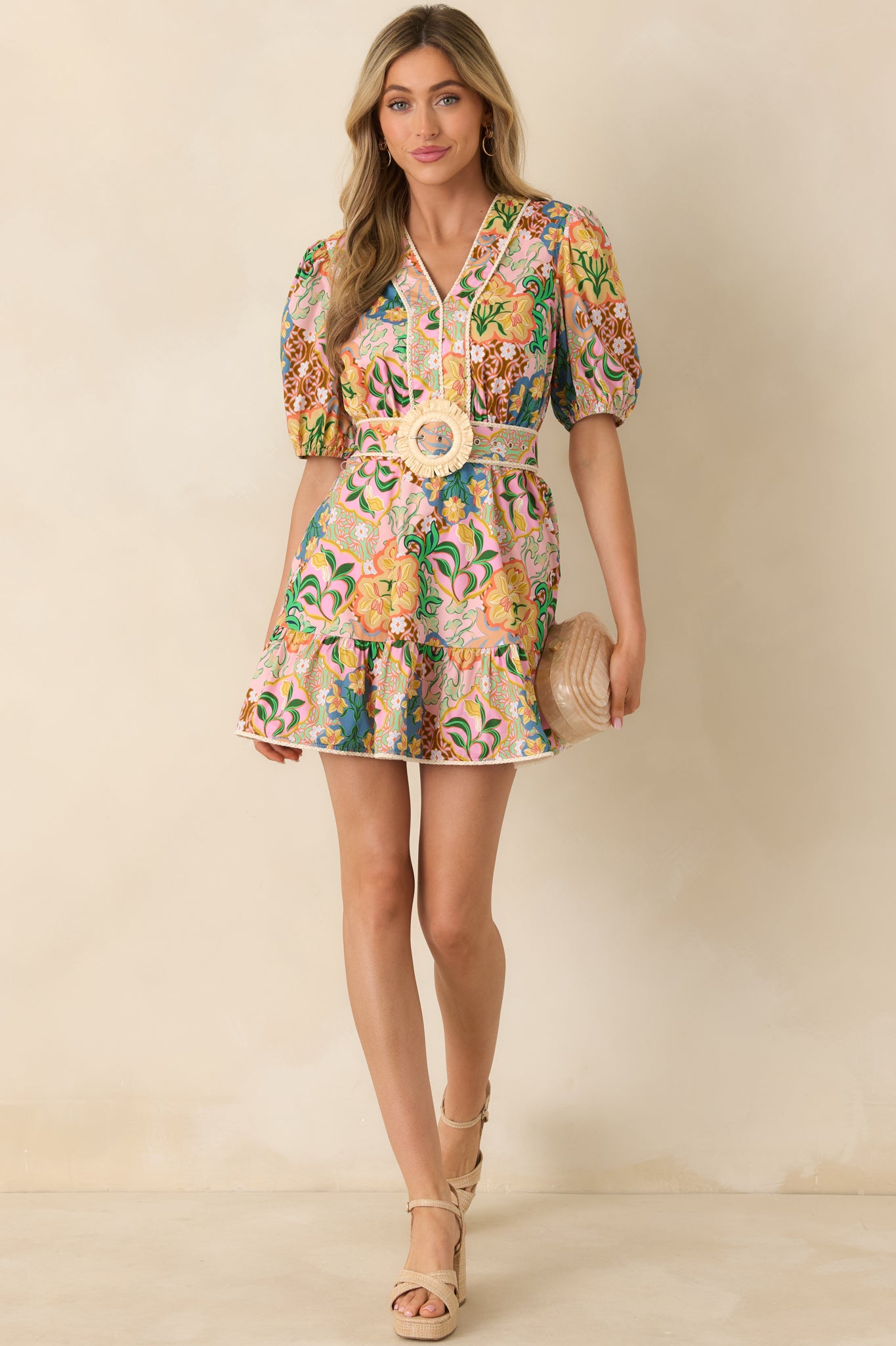 Lightweight pink dress with flattering V-neck, tiered skirt, puff sleeves, and functional front pockets.