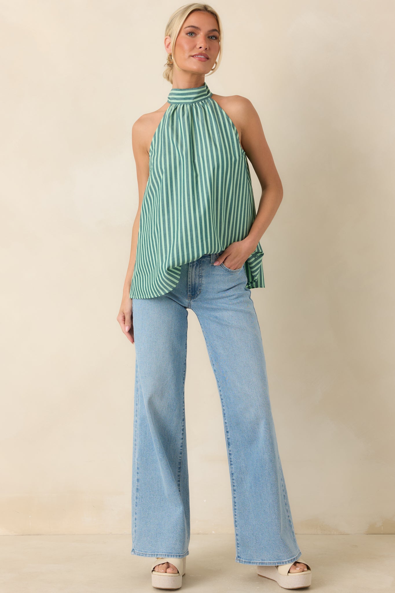 Breezy halter top crafted from lightweight cotton with alternating dark green and mint stripes and an easy relaxed shape.