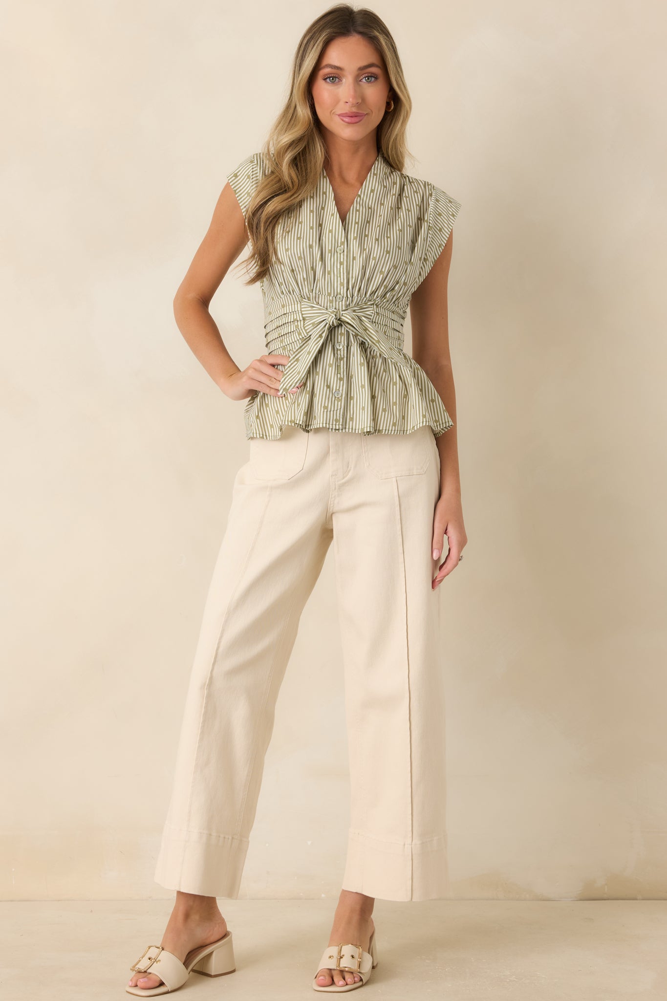 Lightweight striped top with a softly structured silhouette, cap sleeves, and a flattering waist tie detail.
