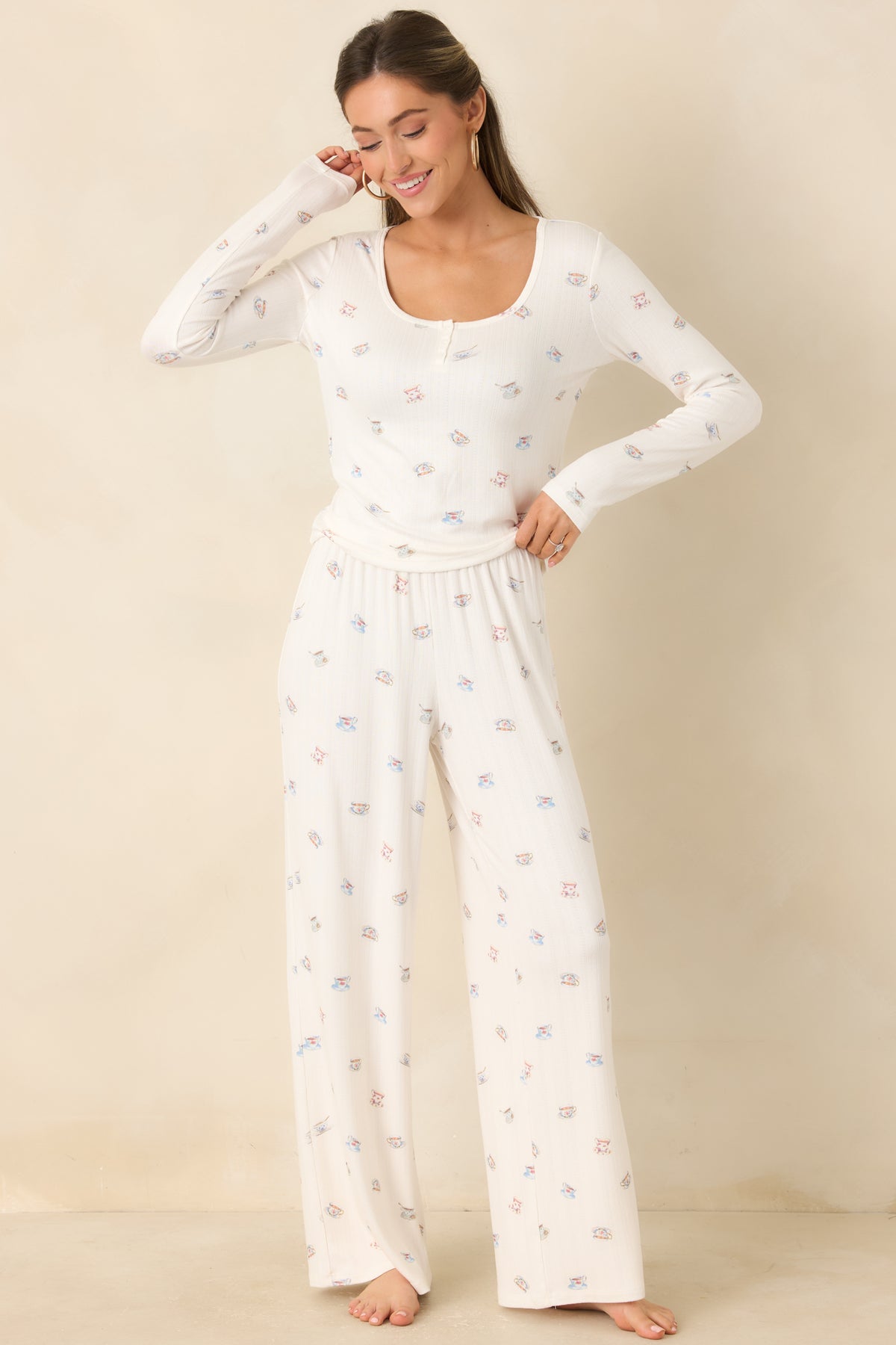 Lightweight teacup-print pants with a flowing wide-leg cut and soft knit texture.