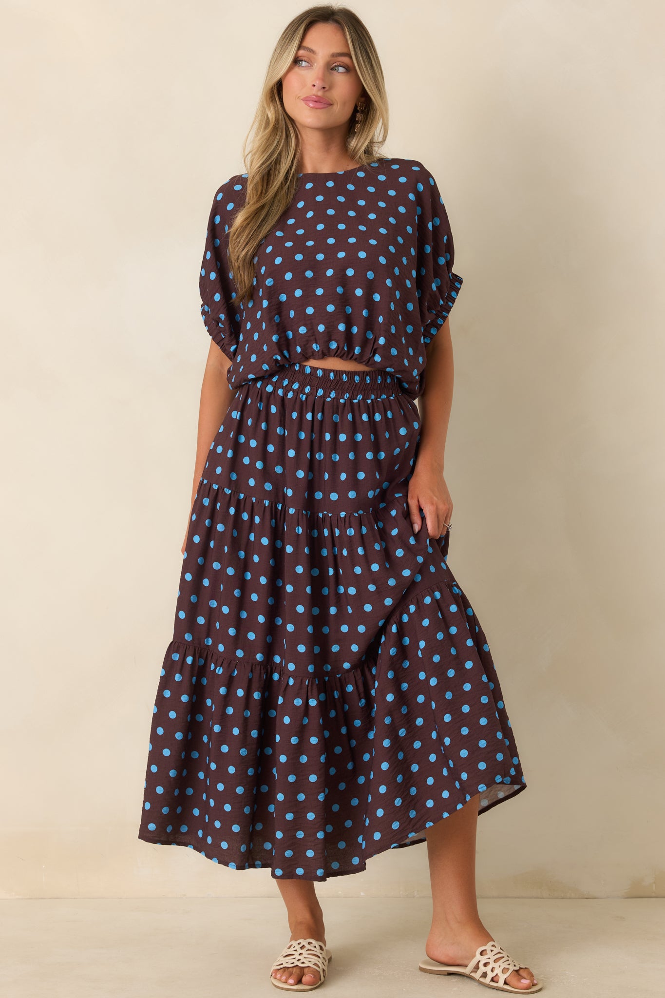 Lightweight viscose blend skirt with a gathered tiered silhouette, smooth lining, and playful blue dot print.