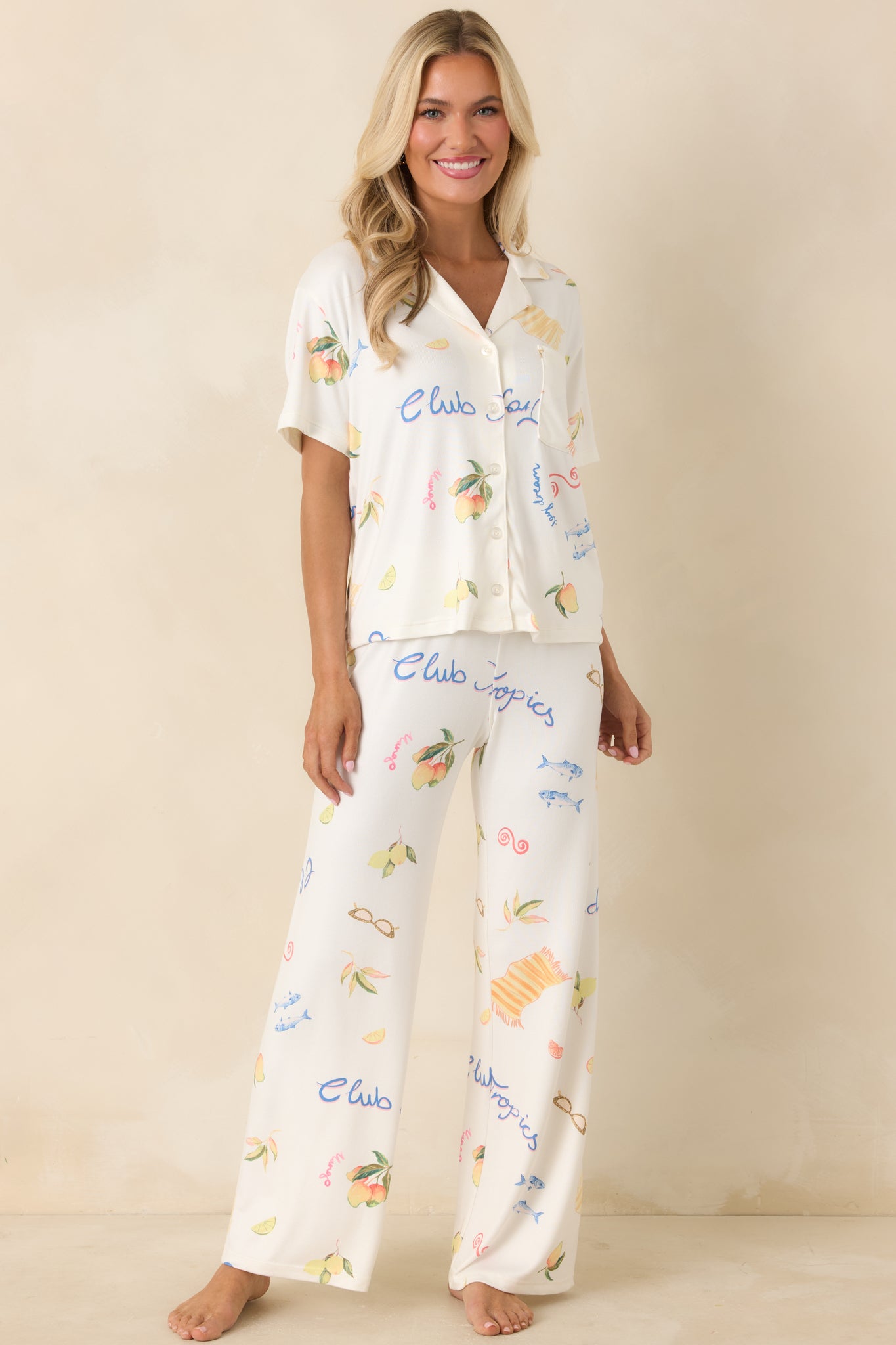 Lightweight wide-leg pants with “Club Tropics” lettering and playful tropical pattern
