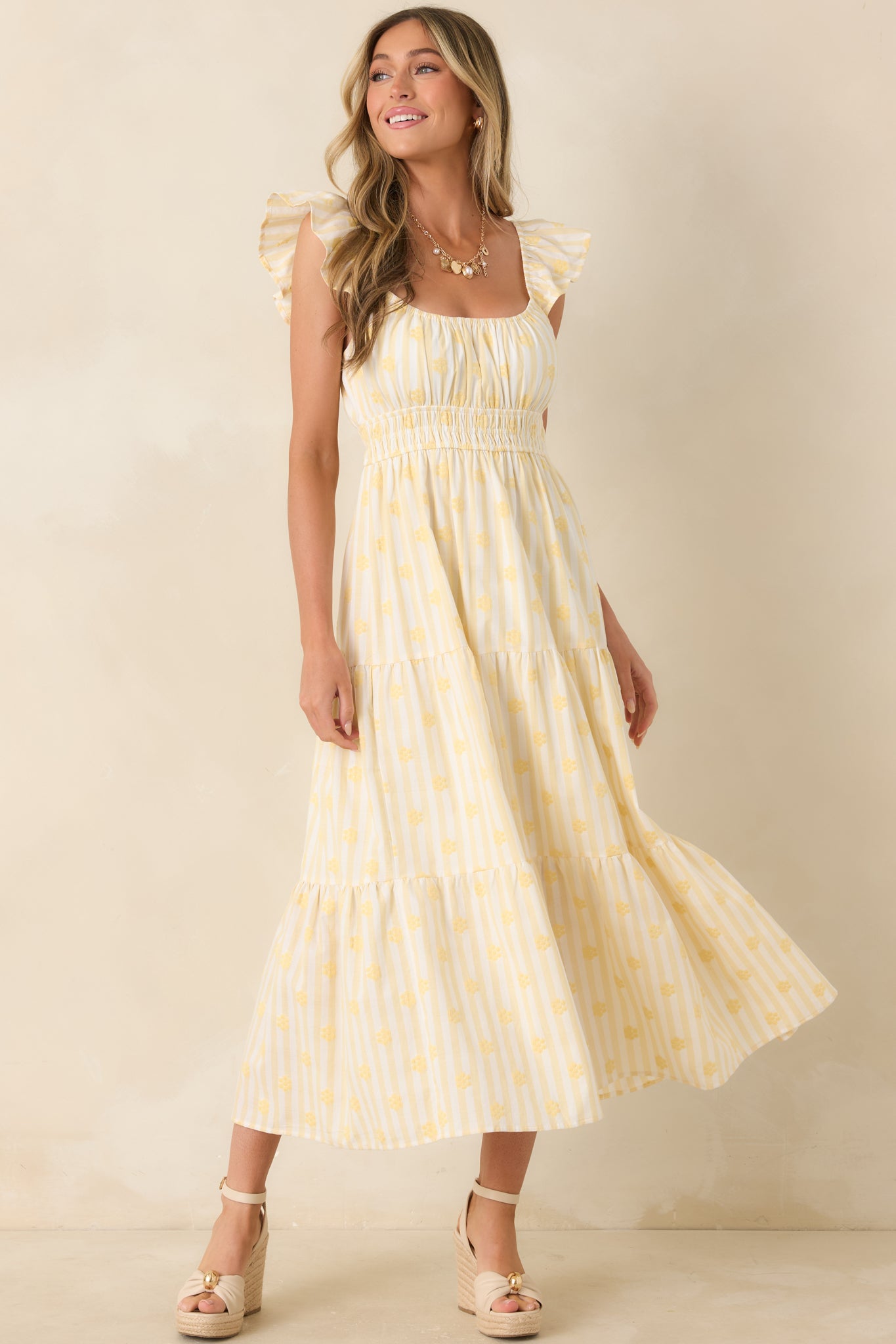 Lightweight yellow maxi dress with subtle stripe detailing, a gathered neckline, and a flowy tiered skirt.