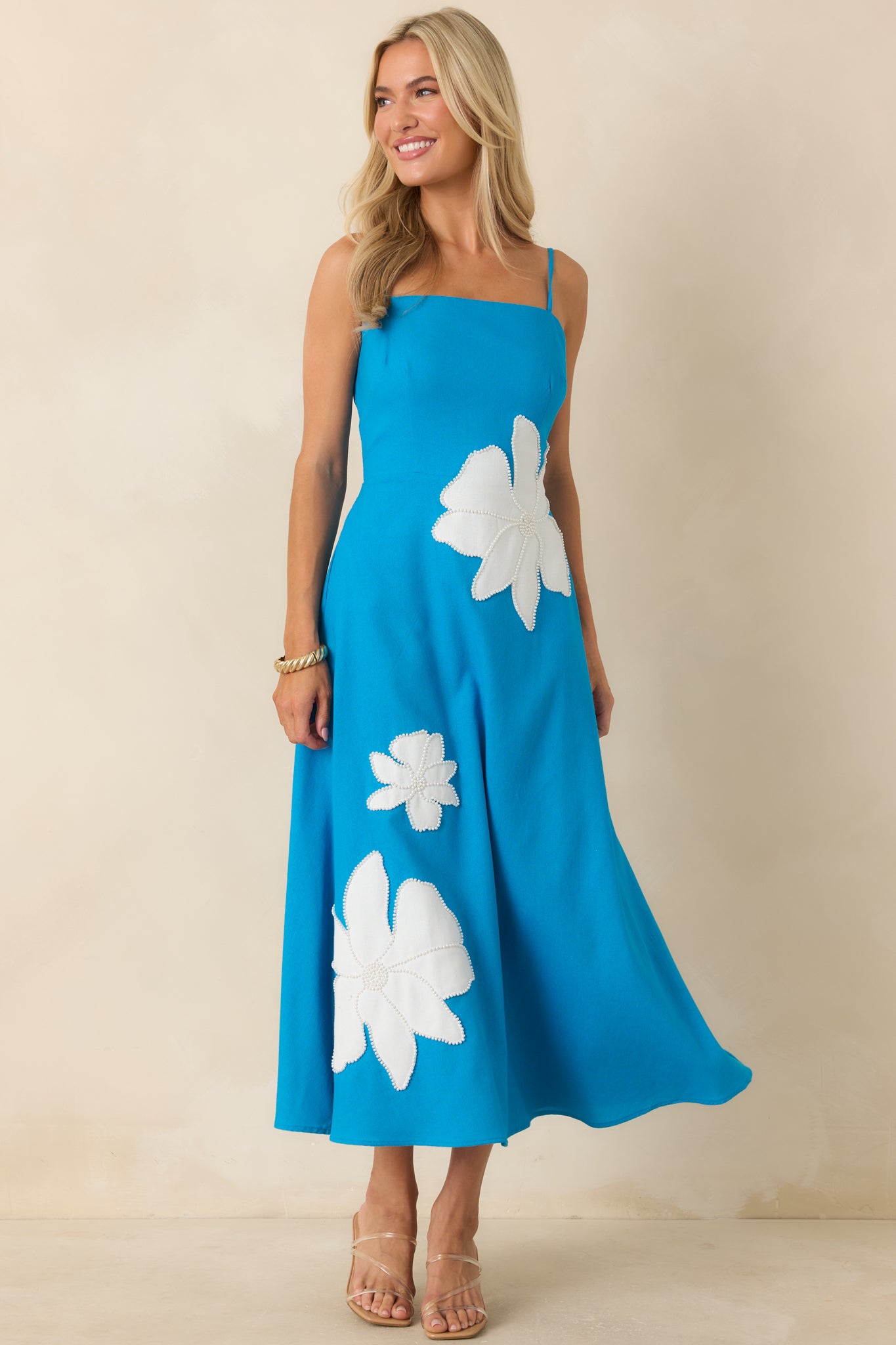 Linen-blend midi dress showcasing a feminine fitted bodice, practical side pockets, and a relaxed A-line shape.