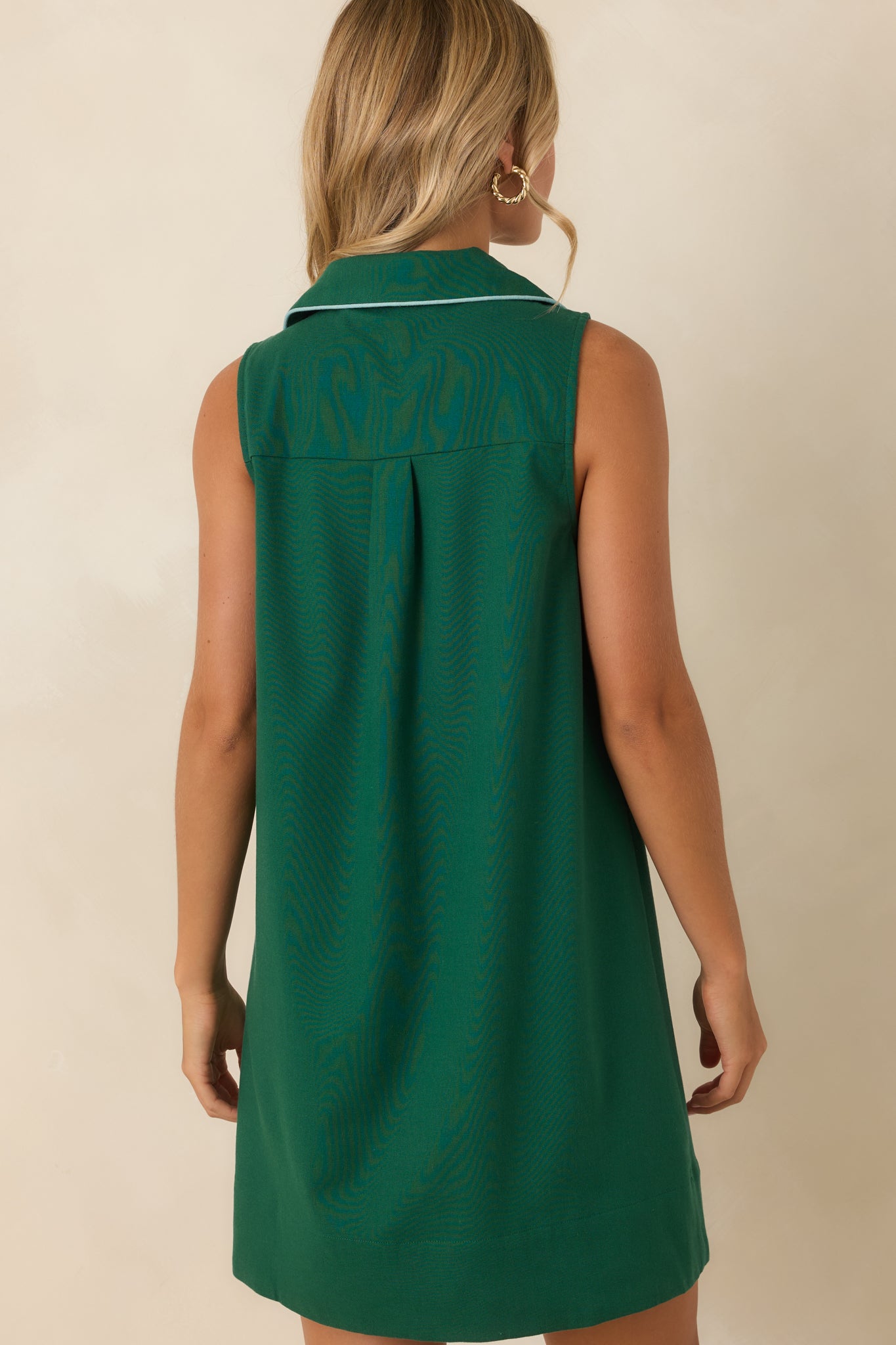 Back view of the linen-blend A-line mini dress featuring a center back pleat for added movement and comfort.