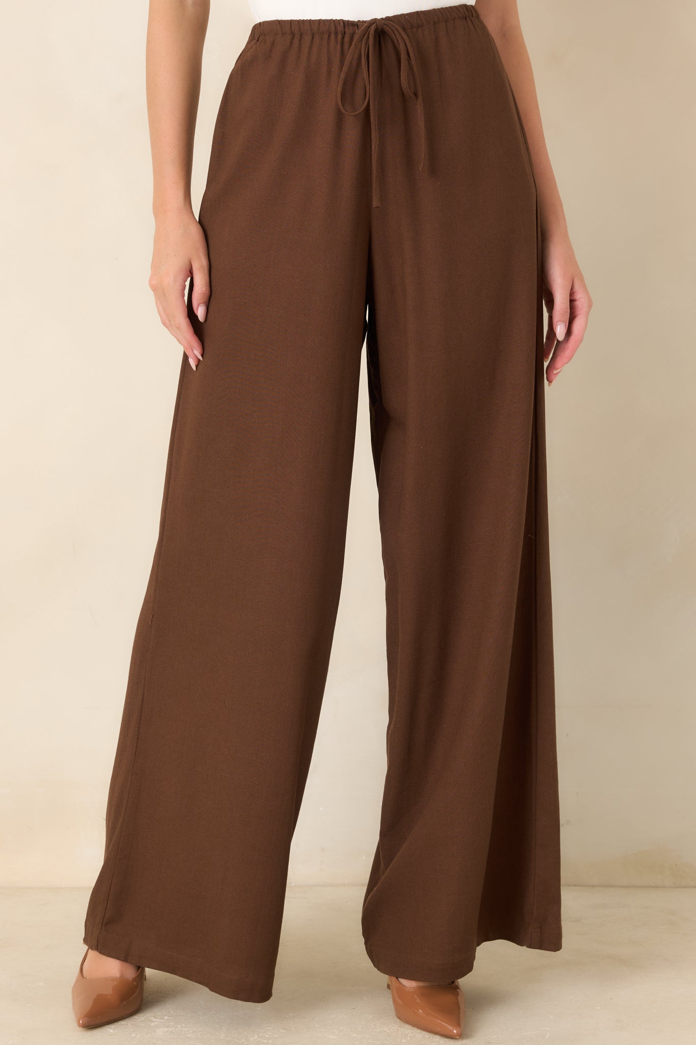 Close view of the linen blend pants highlighting the elastic waistband, decorative tie detail, and soft woven texture.