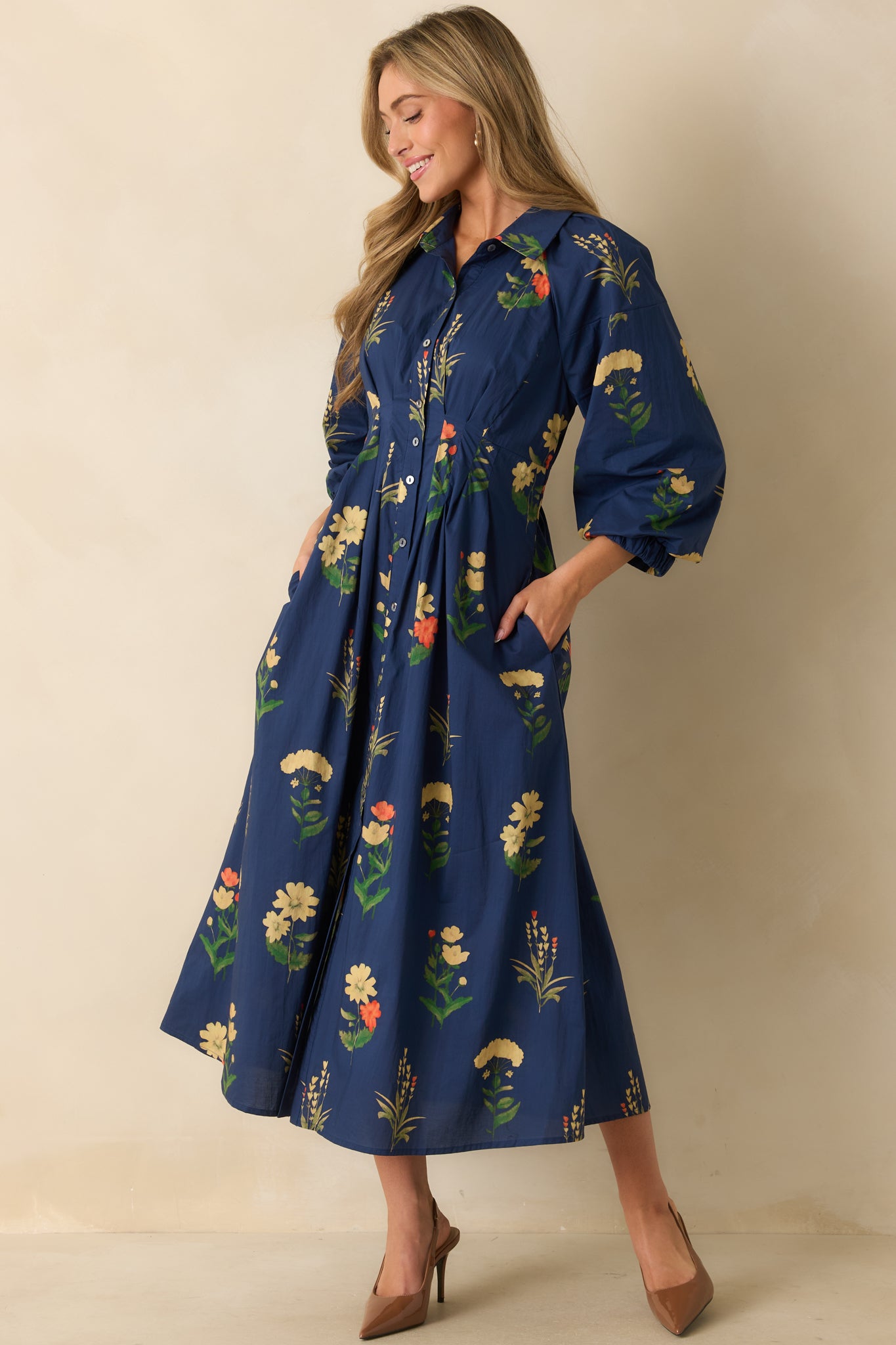 Long-sleeve dress highlighting bishop sleeves with buttoned cuffs and the relaxed A-line silhouette.