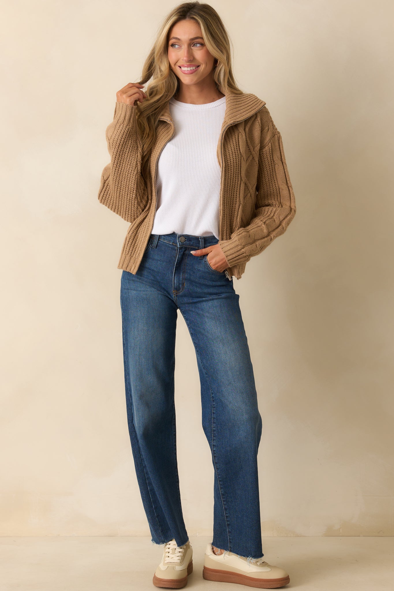 Long-sleeve white top featuring exposed seam detailing and a straight hem.