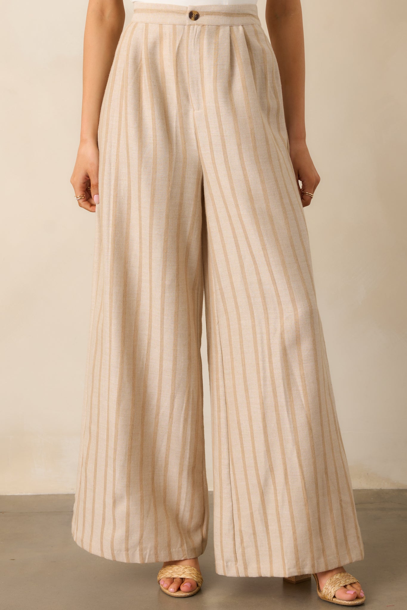 A closer look at the back elastic waist insert, providing flexibility and a comfortable fit to these beige pants.