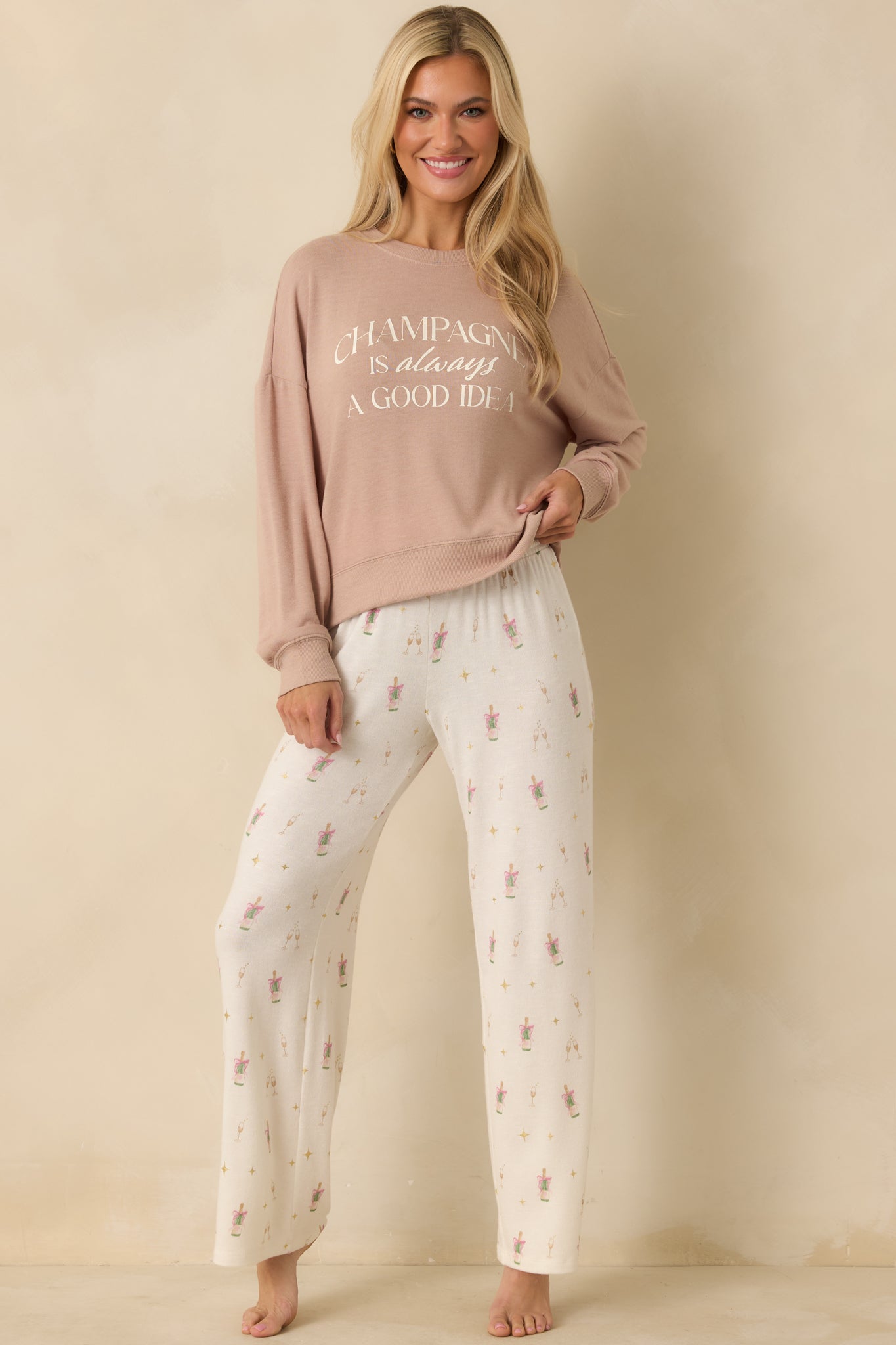Loungewear pants highlighting allover champagne-themed print with gold star accents.