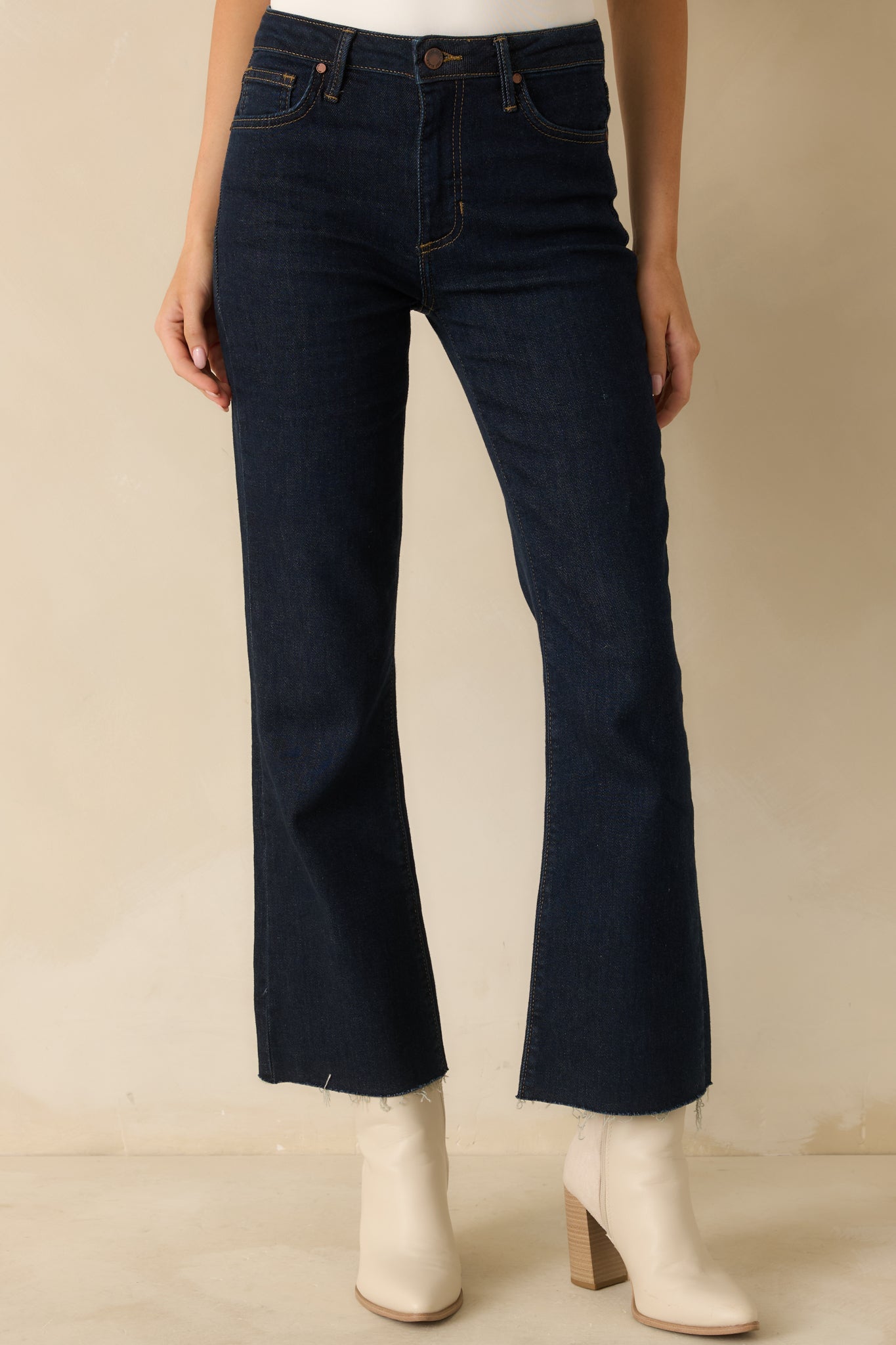 View of the lower front legs showing the slight flare and raw hem edge for a laid-back finish.