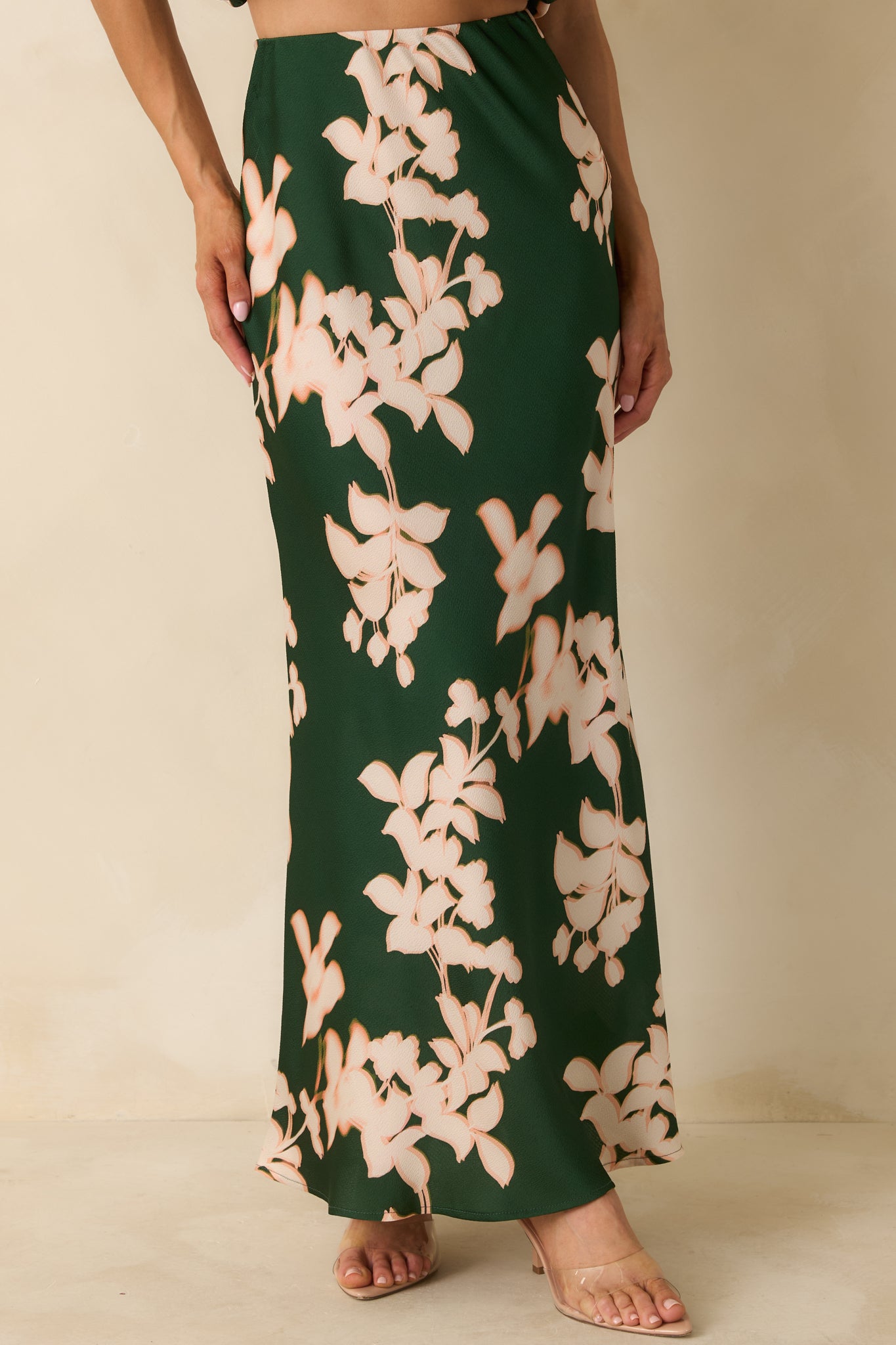 The lower skirt area highlights the flowing fabric, full length, and subtle floral detailing.