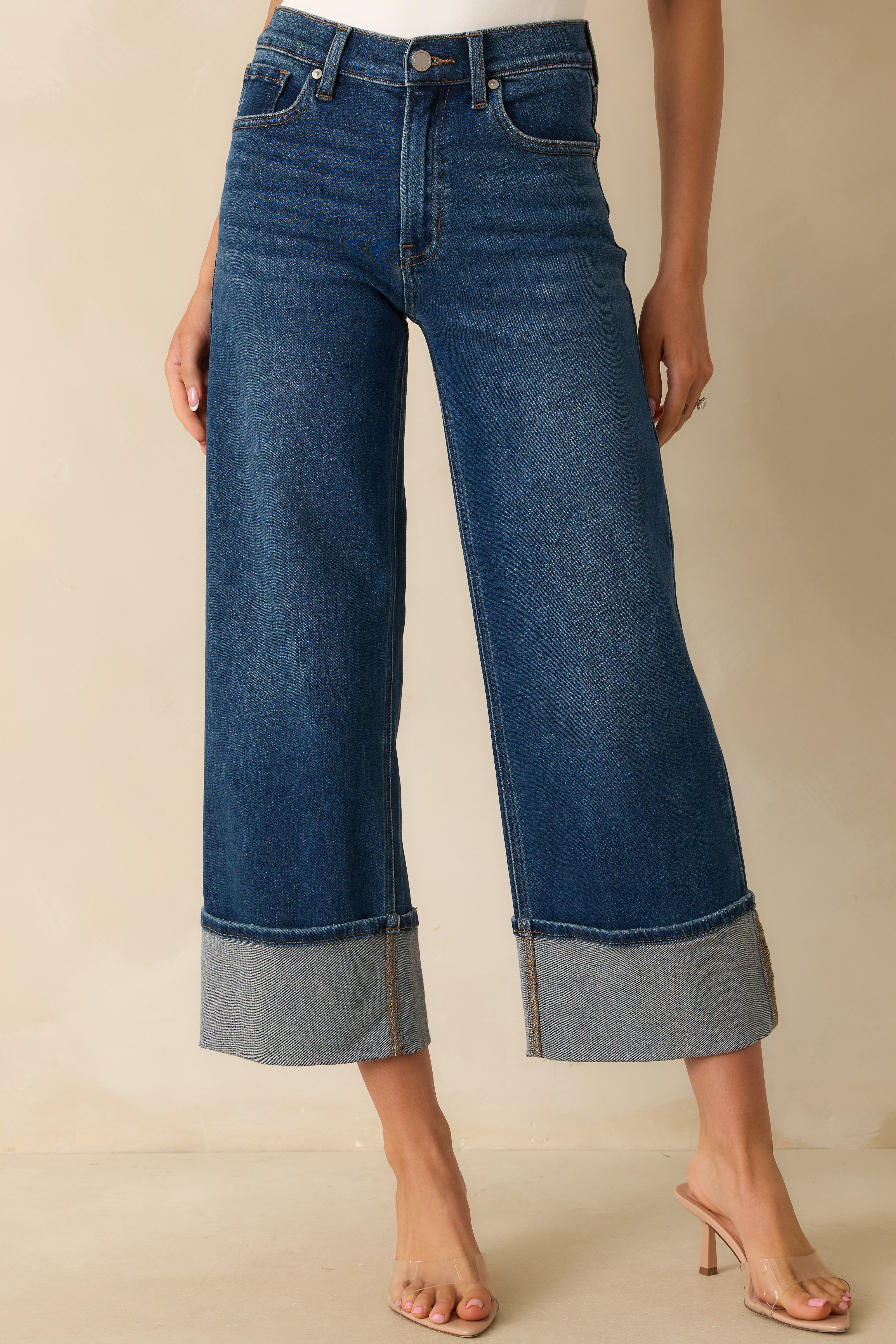 Cropped lower leg view highlighting the wide leg cut and exaggerated cuffed hem.