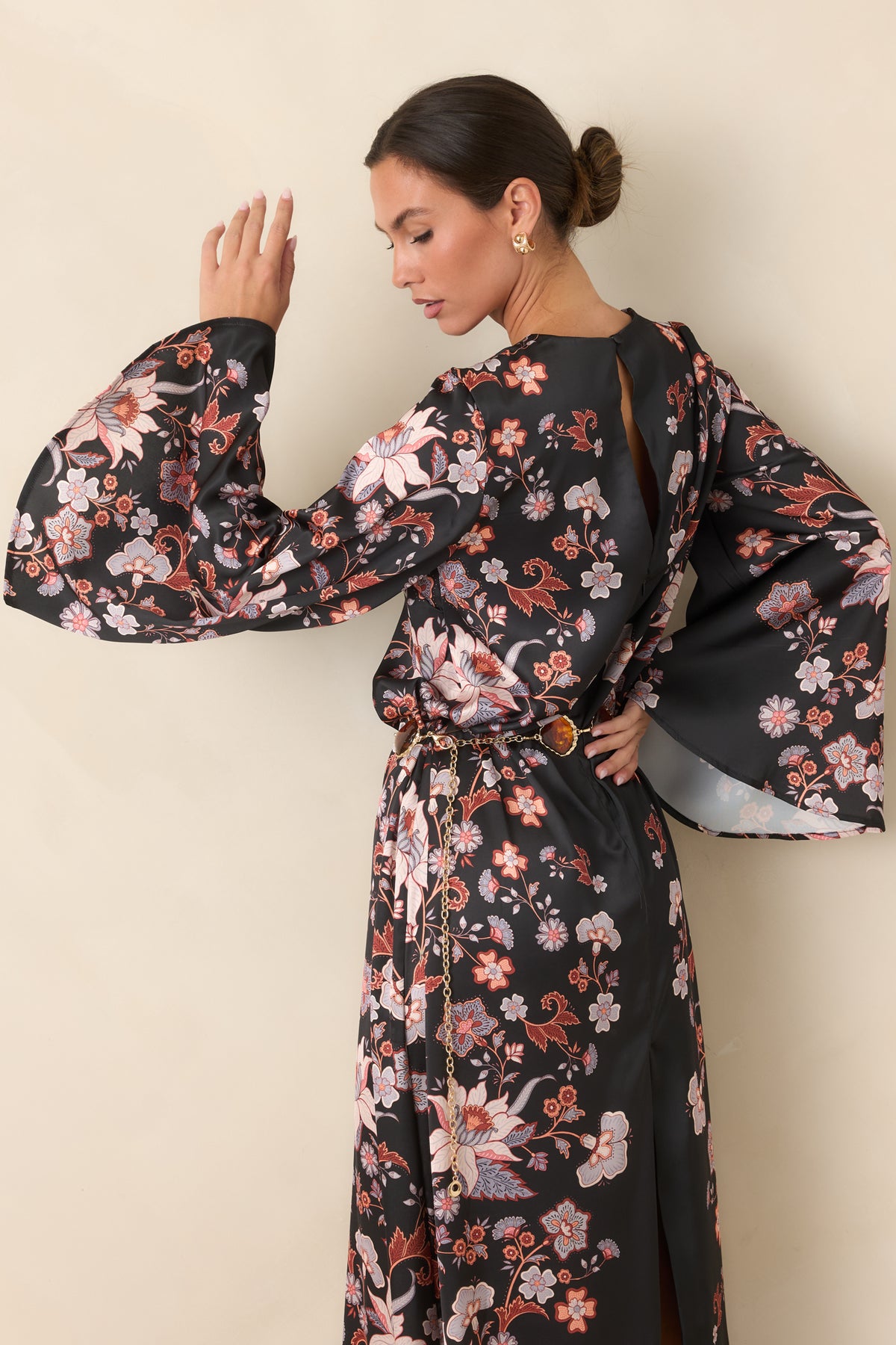 Lustrous black floral maxi dress with a graceful flowing shape and bell sleeves.