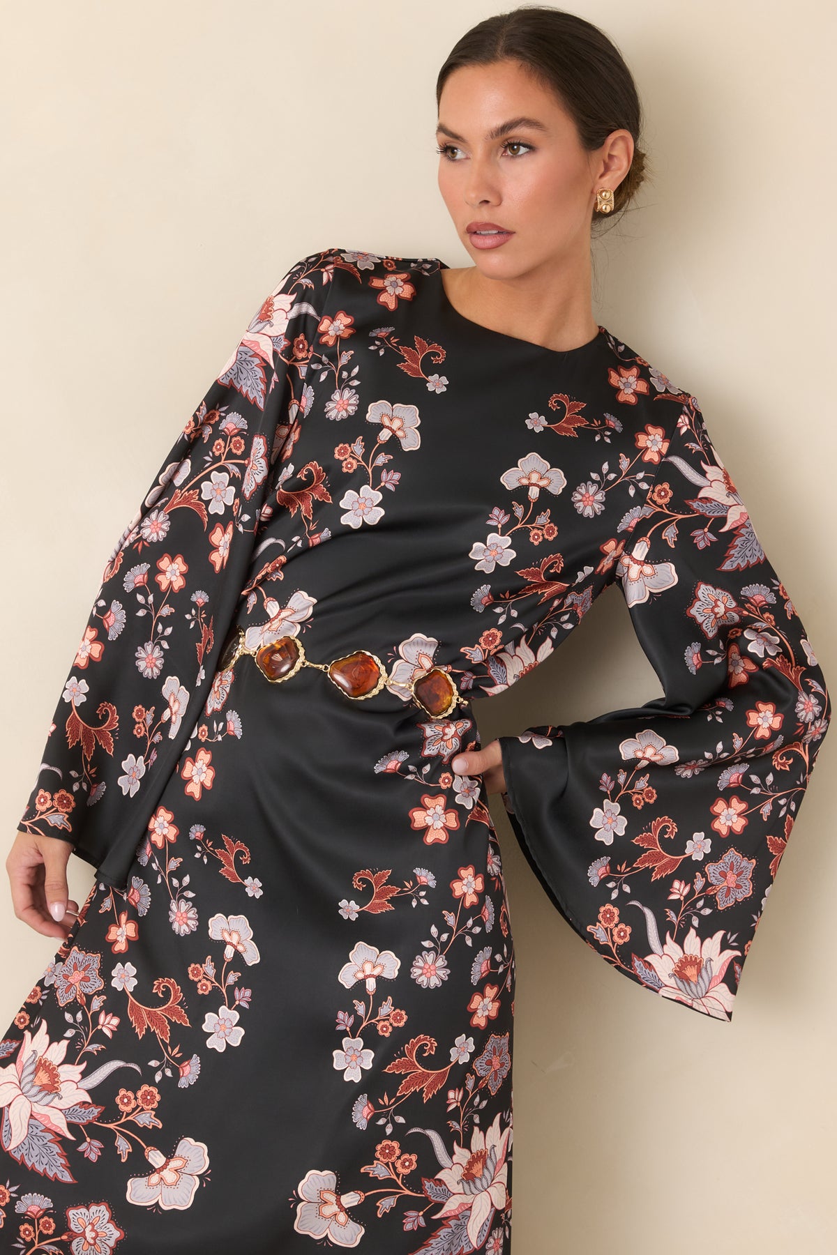 Lustrous satin maxi dress with colorful trailing blooms arranged across the flowing silhouette.