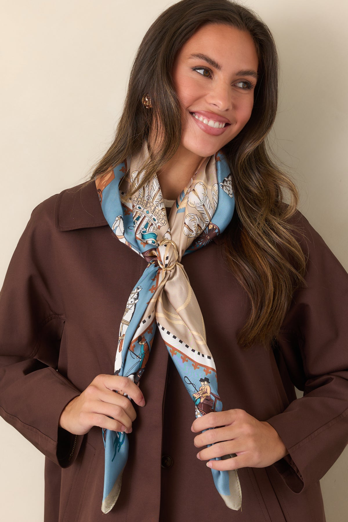 Smooth lustrous scarf showcases an intricate arrangement of horse-drawn carriages and ornate motifs across its vintage-inspired design.