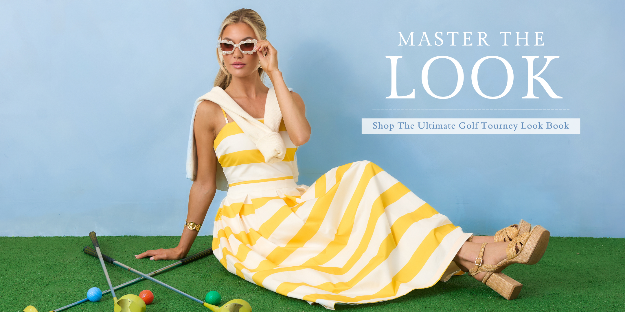 Woman in a yellow and white striped dress sitting on a golf course with text 'Master the Look' above.