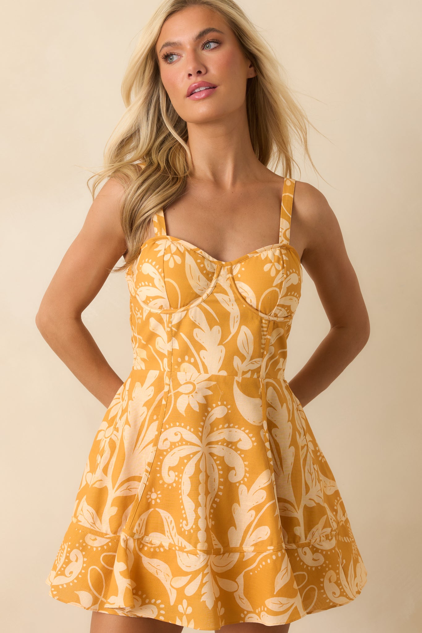 Marigold and ivory print mini dress showcasing the sweetheart neckline and tailored bodice construction.