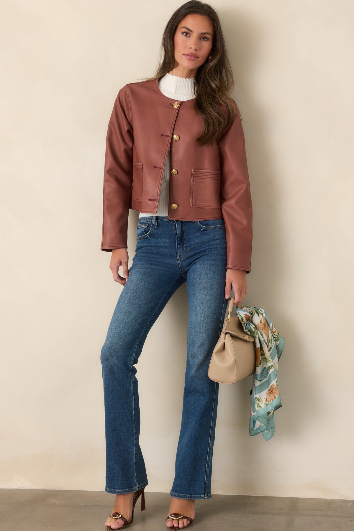 High-rise bootcut jeans in a deep indigo wash, featuring a close-fitting upper silhouette and gently flared hems.