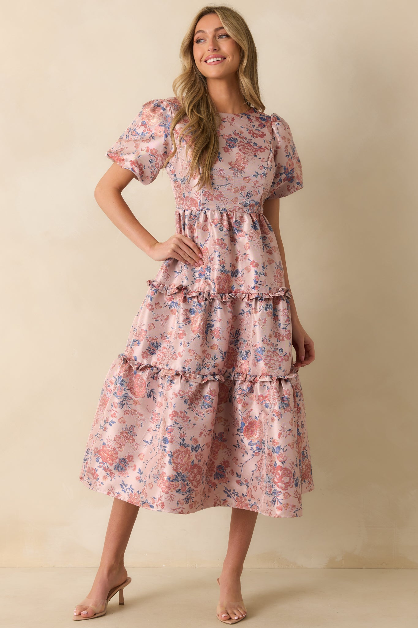 Midi dress highlighting puff sleeves, ruffled tiers, and soft mauve floral pattern.
